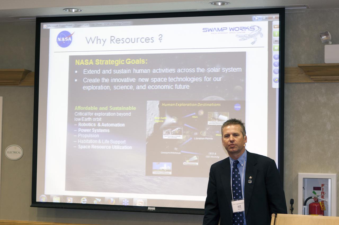 CAPE CANAVERAL, Fla. – At the Courtyard by Marriott hotel in Cocoa Beach, Fla., Rob Mueller, senior technologist in the Surface Systems Office of the Engineering and Technology Directorate at Kennedy Space Center, talks to participants in the room and those participating online during the Third International Workshop on Lunar Superconductor Applications. The workshop included presentations from several engineers and researchers at Kennedy Space Center.  The three-day workshop included presentations from speakers throughout the country and focused on Lunar in-situ resource utilization, NASA’s Lunar Ice Prospector called RESOLVE, CubeSats, cryogenic storage and many other topics related to lunar exploration. Photo credit: NASA_Jim Grossmann
