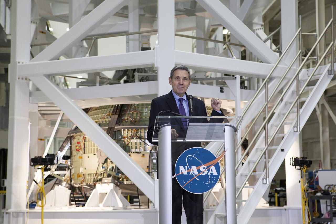 CAPE CANAVERAL, Fla. – In the Operations and Checkout Building OandC at the Kennedy Space Center in Florida, Kennedy Director Bob Cabana speaks to news media representatives updating progress on preparing the Orion spacecraft for its first uncrewed mission, Exploration Flight Test-1 EFT-1 in 2014. The crew module is seen behind Cabana in its test stand. Launched atop NASA's heavy-lift Space Launch System rocket, Orion is now targeted to take astronauts in a sample return mission to an asteroid as early as 2021. On the third anniversary of President Barack Obama issuing his challenge to NASA to send astronauts to an asteroid, news media representatives were given an opportunity to see up-close the Orion spacecraft which could take astronauts on such a flight. They also heard from key leaders of that effort in Kennedy's OandC where Orion's assembly is taking place. Photo credit: NASA_Kim Shiflett