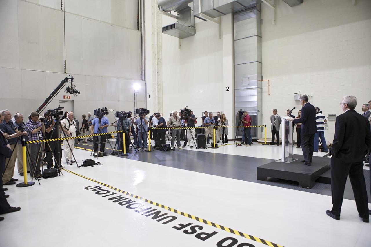 CAPE CANAVERAL, Fla. – In the Operations and Checkout Building OandC at the Kennedy Space Center in Florida, Kennedy Director Bob Cabana on the podium to the right speaks to news media representatives updating progress on preparing the Orion spacecraft for its first uncrewed mission, Exploration Flight Test-1 EFT-1 in 2014. Launched atop NASA's heavy-lift Space Launch System rocket, Orion is now targeted to take astronauts in a sample return mission to an asteroid as early as 2021. On the third anniversary of President Barack Obama issuing his challenge to NASA to send astronauts to an asteroid, news media representatives were given an opportunity to see up-close the Orion spacecraft which could take astronauts on such a flight. They also heard from key leaders of that effort in Kennedy's OandC where Orion's assembly is taking place. Photo credit: NASA_Kim Shiflett