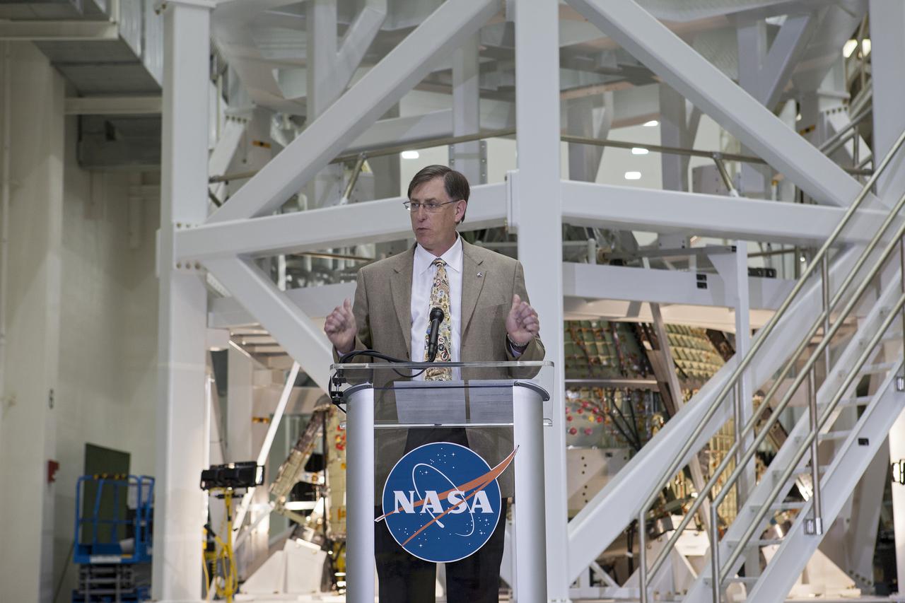 CAPE CANAVERAL, Fla. – In the Operations and Checkout Building OandC at the Kennedy Space Center in Florida, Dan Dumbacher, NASA's deputy associate administrator for Exploration Systems Development, speaks to news media representatives updating progress on preparing the Orion spacecraft for its first uncrewed mission, Exploration Flight Test-1 EFT-1 in 2014. The crew module is seen behind Dumbacher in its test stand. Launched atop NASA's heavy-lift Space Launch System rocket, Orion is now targeted to take astronauts in a sample return mission to an asteroid as early as 2021. On the third anniversary of President Barack Obama issuing his challenge to NASA to send astronauts to an asteroid, news media representatives were given an opportunity to see up-close the Orion spacecraft which could take astronauts on such a flight. They also heard from key leaders of that effort in Kennedy's OandC where Orion's assembly is taking place. Photo credit: NASA_Kim Shiflett