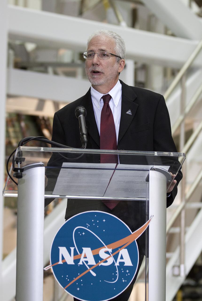 CAPE CANAVERAL, Fla. – In the Operations and Checkout Building OandC at the Kennedy Space Center in Florida, Mark Geyer, NASA's Orion program manager, speaks to news media representatives updating progress on preparing the Orion spacecraft for its first uncrewed mission, Exploration Flight Test-1 EFT-1 in 2014. Launched atop NASA's heavy-lift Space Launch System rocket, Orion is now targeted to take astronauts in a sample return mission to an asteroid as early as 2021. On the third anniversary of President Barack Obama issuing his challenge to NASA to send astronauts to an asteroid, news media representatives were given an opportunity to see up-close the Orion spacecraft which could take astronauts on such a flight. They also heard from key leaders of that effort in Kennedy's OandC where Orion's assembly is taking place. Photo credit: NASA_Kim Shiflett
