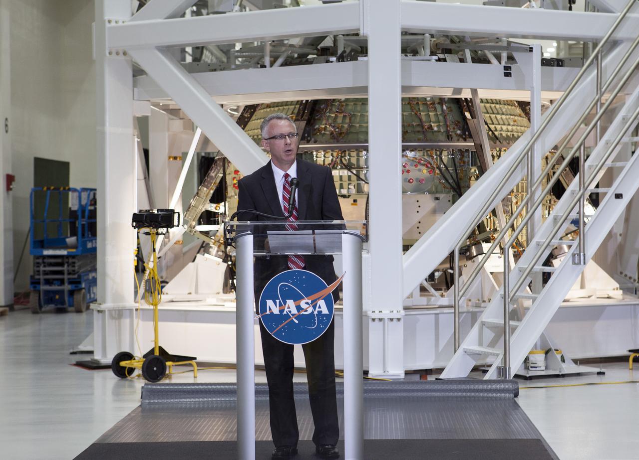 CAPE CANAVERAL, Fla. – In the Operations and Checkout Building OandC at the Kennedy Space Center in Florida, Keith Hefner, NASA's Space Launch System program planning and control manager, speaks to news media representatives updating progress on preparing the Orion spacecraft for its first uncrewed mission, Exploration Flight Test-1 EFT-1 in 2014. The crew module is seen behind Hefner in its test stand. Launched atop NASA's heavy-lift Space Launch System rocket, Orion is now targeted to take astronauts in a sample return mission to an asteroid as early as 2021. On the third anniversary of President Barack Obama issuing his challenge to NASA to send astronauts to an asteroid, news media representatives were given an opportunity to see up-close the Orion spacecraft which could take astronauts on such a flight. They also heard from key leaders of that effort in Kennedy's OandC where Orion's assembly is taking place. Photo credit: NASA_Kim Shiflett