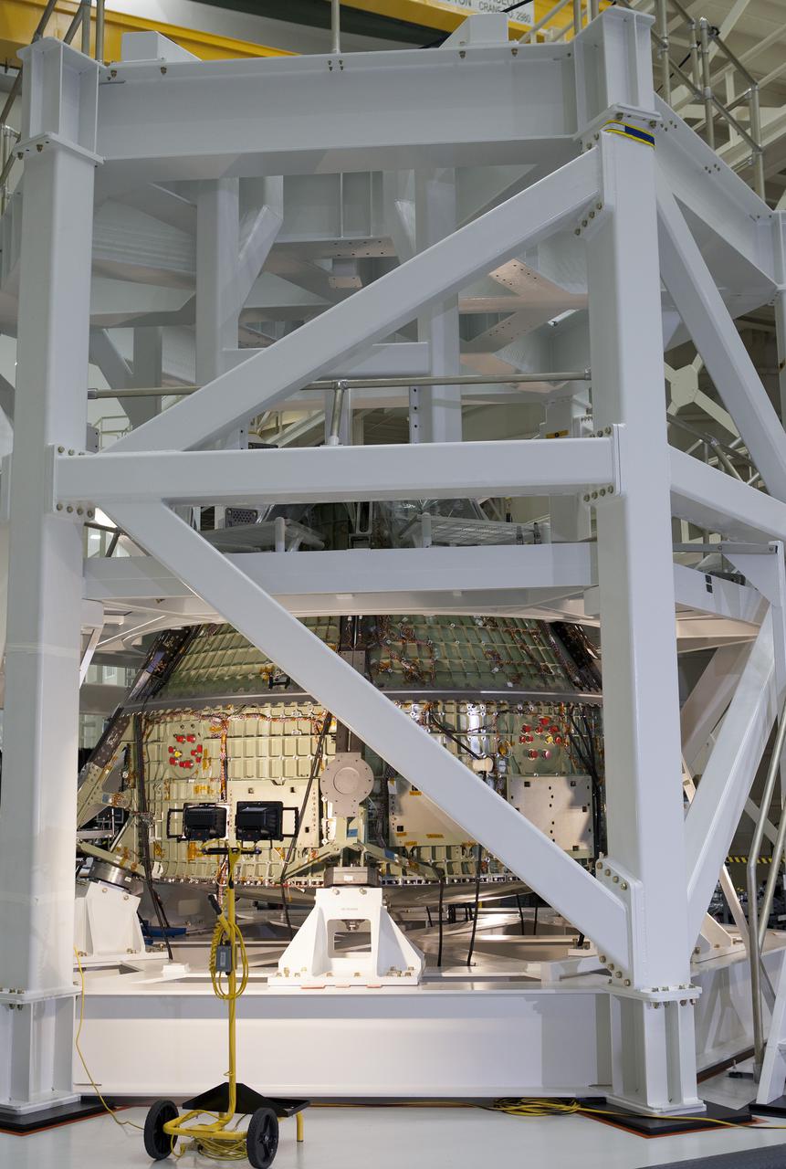 CAPE CANAVERAL, Fla. – In the Operations and Checkout Building OandC at the Kennedy Space Center in Florida, the Orion spacecraft for its first uncrewed mission, Exploration Flight Test-1 EFT-1 in 2014. The Orion is seen in its test stand preparing for a Static Loads test. Launched atop NASA's heavy-lift Space Launch System rocket, Orion is now targeted to take astronauts in a sample return mission to an asteroid as early as 2021. On the third anniversary of President Barack Obama issuing his challenge to NASA to send astronauts to an asteroid, news media representatives were given an opportunity to see up-close the Orion spacecraft which could take astronauts on such a flight. They also heard from key leaders of that effort in Kennedy's OandC where Orion's assembly is taking place. Photo credit: NASA_Kim Shiflett