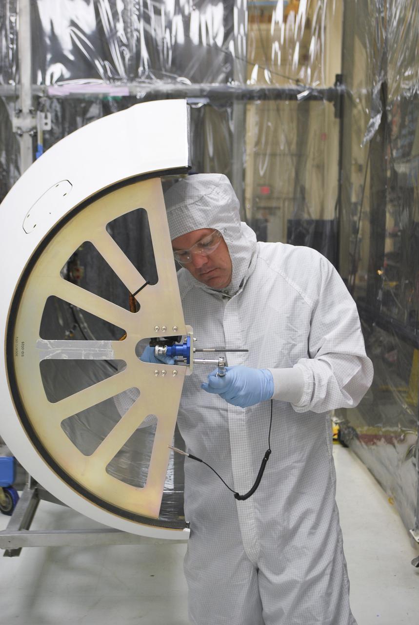 VANDENBERG AFB, Calif. – A technician works on the payload fairing that will protect NASA's IRIS spacecraft during launch aboard an Orbital Sciences Pegasus XL rocket. NASA’s Interface Region Imaging Spectrograph, or IRIS, satellite will improve our understanding of how heat and energy move through the deepest levels of the sun’s atmosphere, thereby increasing our ability to forecast space weather. On launch day, deployment of the Pegasus from Orbital’s L-1011 carrier aircraft will occur at a location over the Pacific Ocean about 100 miles northwest of Vandenberg off the central coast of California south of Big Sur. Photo credit: VAFB_Randy Beaudoin