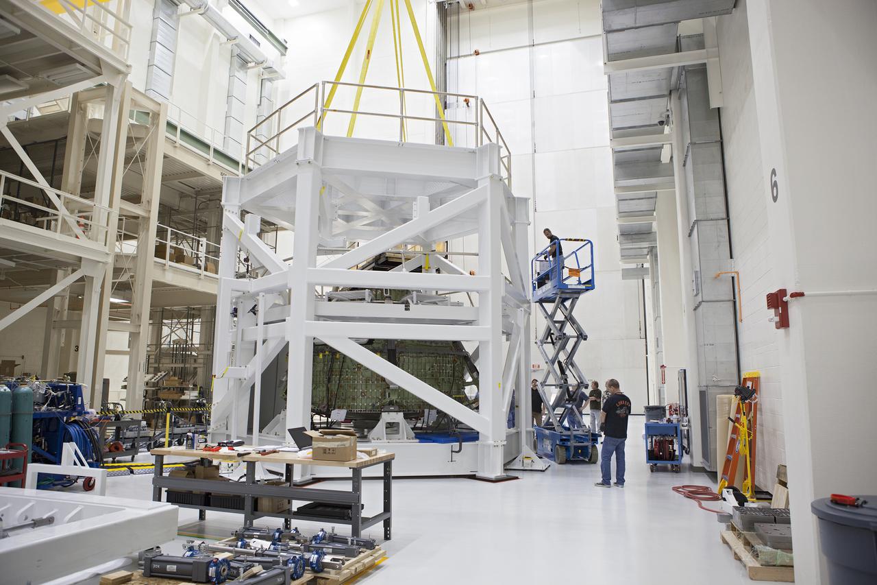 CAPE CANAVERAL, Fla. – Inside the Operations and Checkout Building high bay at NASA’s Kennedy Space Center in Florida, technicians have attached the top platform to the test stand for the Orion crew module. Lockheed Martin Space Systems and NASA engineers are preparing Orion for a series of static load tests that simulate the massive loads the spacecraft would experience during its mission. Orion is the exploration spacecraft designed to carry crews to space beyond low Earth orbit. It will provide emergency abort capability, sustain the crew during the space travel and provide safe re-entry from deep space return velocities. Orion’s first unpiloted test flight, Exploration Flight Test 1, is scheduled to launch in 2014 atop a Delta IV rocket. A second uncrewed flight test is scheduled for 2017 on NASA’s Space Launch System rocket. For more information, visit http:__www.nasa.gov_orion. Photo credit: NASA_Gary Thompson