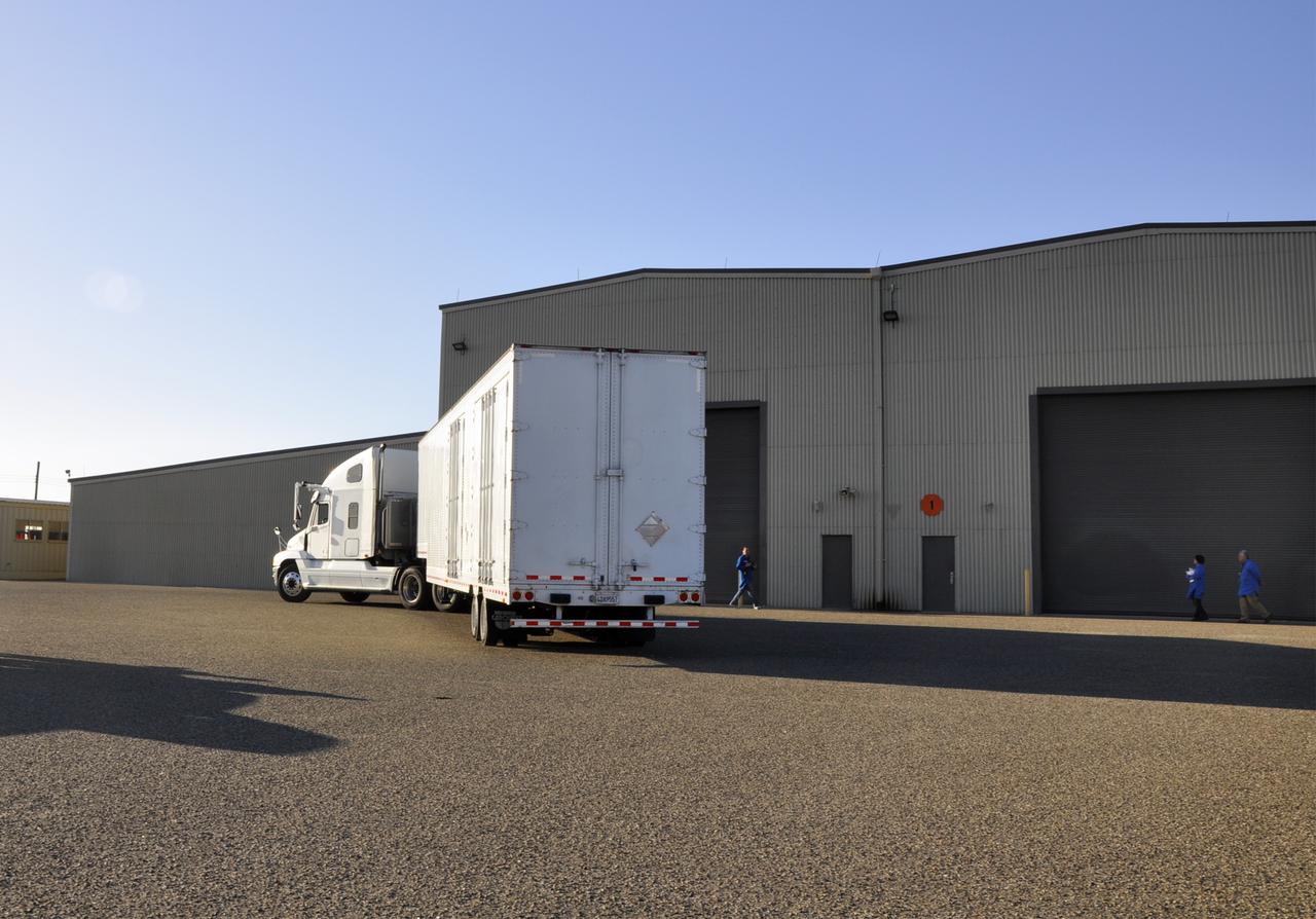 VANDENBERG AFB, Calif. – A truck carrying NASA's IRIS spacecraft nears the processing facility at Vandenberg where the spacecraft will be readied for launch aboard an Orbital Sciences Pegasus XL rocket. IRIS is short for Interface Region Imaging Spectrograph and the spacecraft's mission will improve our understanding of how heat and energy move through the deepest levels of the sun’s atmosphere, thereby increasing our ability to forecast space weather. Photo credit: VAFB_Randy Beaudoin