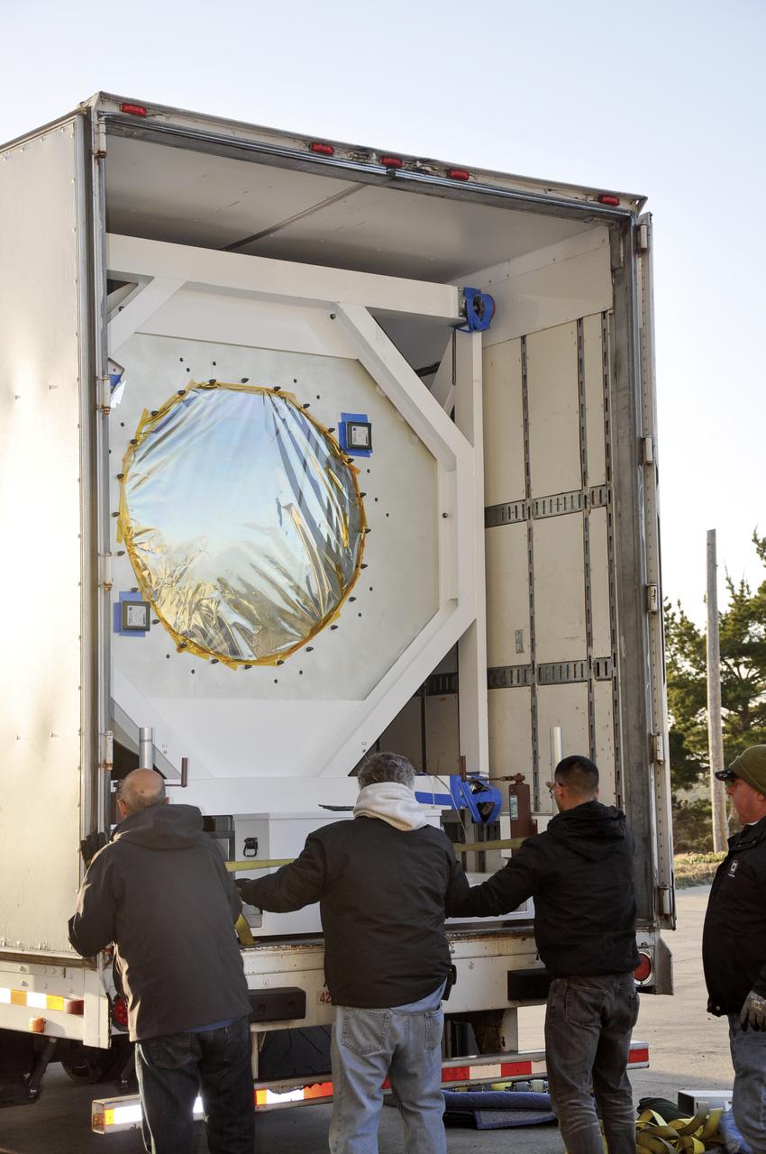 VANDENBERG AFB, Calif. – Workers prepare to unload NASA's IRIS spacecraft from a truck at the processing facility at Vandenberg where the spacecraft will be readied for launch aboard an Orbital Sciences Pegasus XL rocket. IRIS is short for Interface Region Imaging Spectrograph and the spacecraft's mission will improve our understanding of how heat and energy move through the deepest levels of the sun’s atmosphere, thereby increasing our ability to forecast space weather. Photo credit: VAFB_Randy Beaudoin