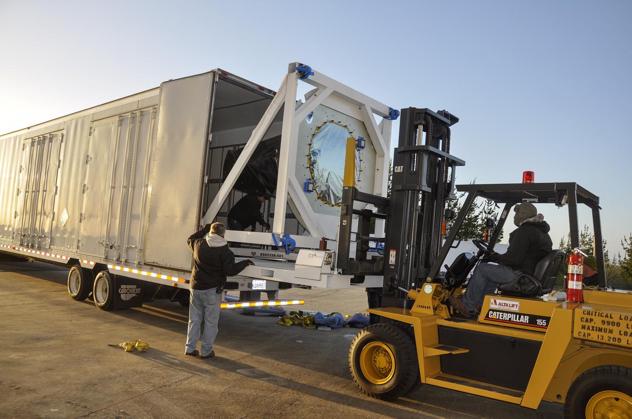 VANDENBERG AFB, Calif. – Workers unload NASA's IRIS spacecraft from a truck at the processing facility at Vandenberg where the spacecraft will be readied for launch aboard an Orbital Sciences Pegasus XL rocket. IRIS is short for Interface Region Imaging Spectrograph and the spacecraft's mission will improve our understanding of how heat and energy move through the deepest levels of the sun’s atmosphere, thereby increasing our ability to forecast space weather. Photo credit: VAFB_Randy Beaudoin