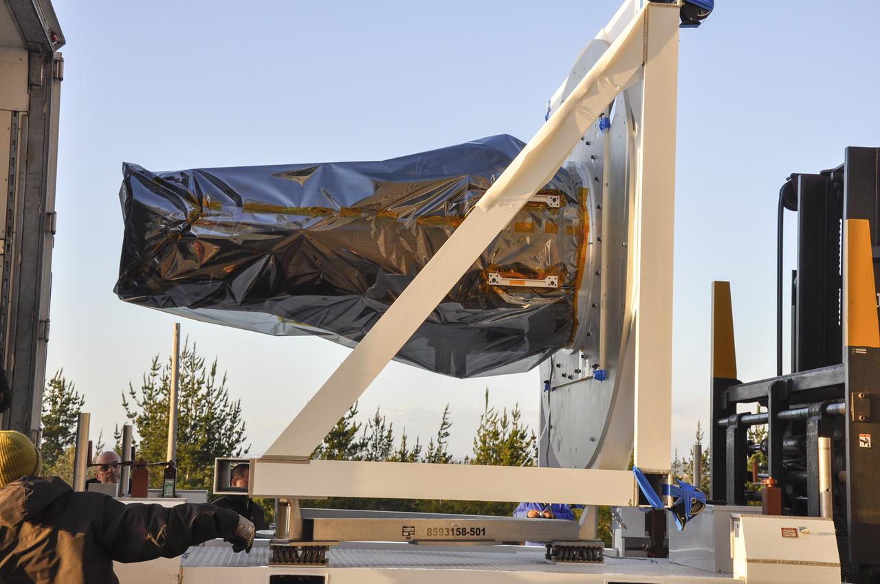 VANDENBERG AFB, Calif. – Workers unload NASA's IRIS spacecraft from a truck at the processing facility at Vandenberg where the spacecraft will be readied for launch aboard an Orbital Sciences Pegasus XL rocket. IRIS is short for Interface Region Imaging Spectrograph and the spacecraft's mission will improve our understanding of how heat and energy move through the deepest levels of the sun’s atmosphere, thereby increasing our ability to forecast space weather. Photo credit: VAFB_Randy Beaudoin