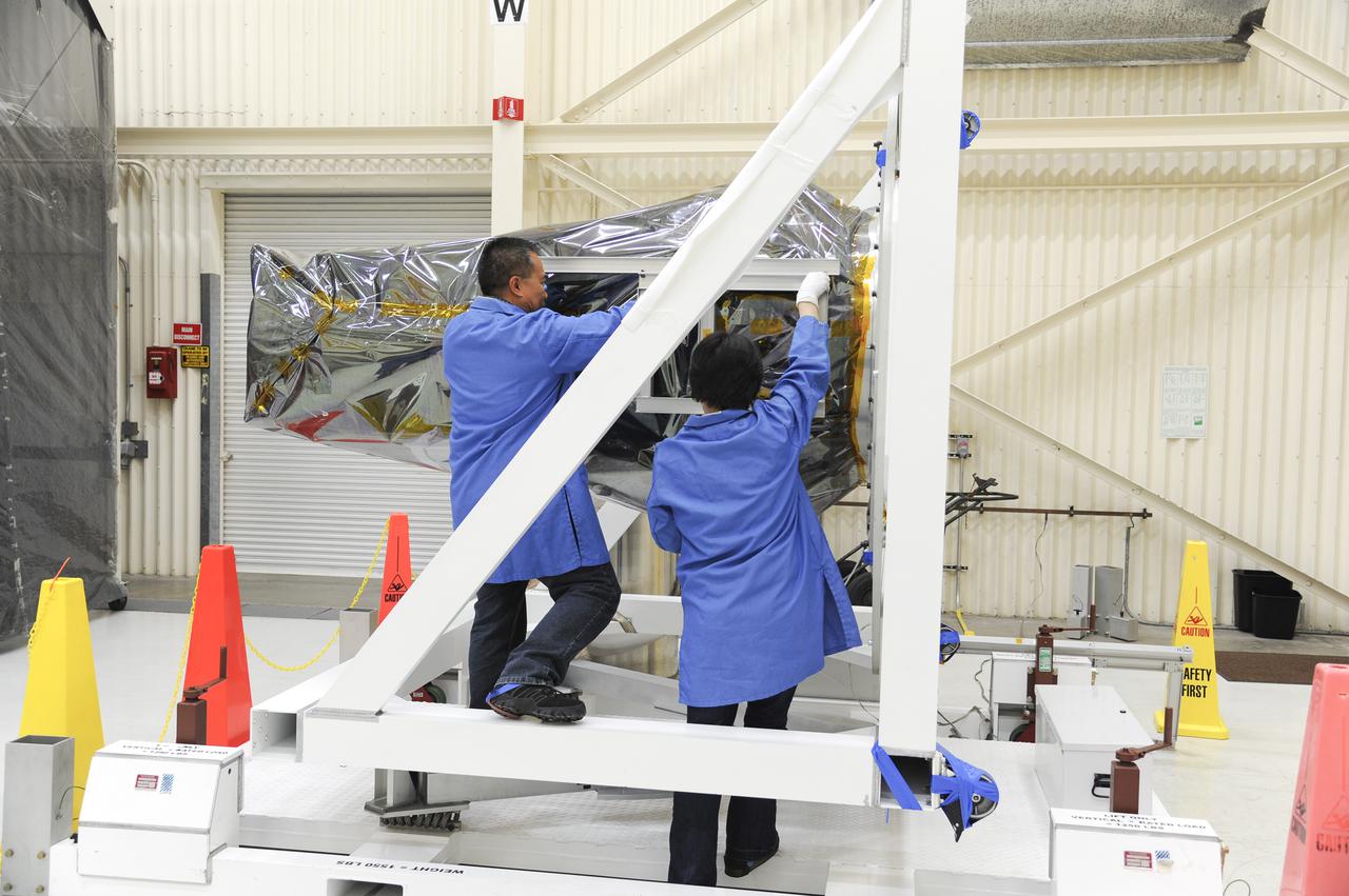 VANDENBERG AFB, Calif. – Technicians begin processing NASA's IRIS spacecraft at Vandenberg where the spacecraft will be readied for launch aboard an Orbital Sciences Pegasus XL rocket. IRIS is short for Interface Region Imaging Spectrograph and the spacecraft's mission will improve our understanding of how heat and energy move through the deepest levels of the sun’s atmosphere, thereby increasing our ability to forecast space weather. Photo credit: VAFB_Doug Gruber