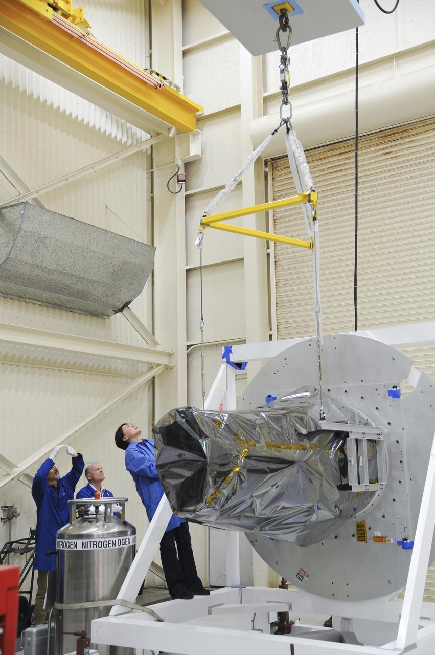 VANDENBERG AFB, Calif. – Technicians get ready to lift NASA's IRIS spacecraft at Vandenberg where the spacecraft will be readied for launch aboard an Orbital Sciences Pegasus XL rocket. IRIS is short for Interface Region Imaging Spectrograph and the spacecraft's mission will improve our understanding of how heat and energy move through the deepest levels of the sun’s atmosphere, thereby increasing our ability to forecast space weather. Photo credit: VAFB_Doug Gruber