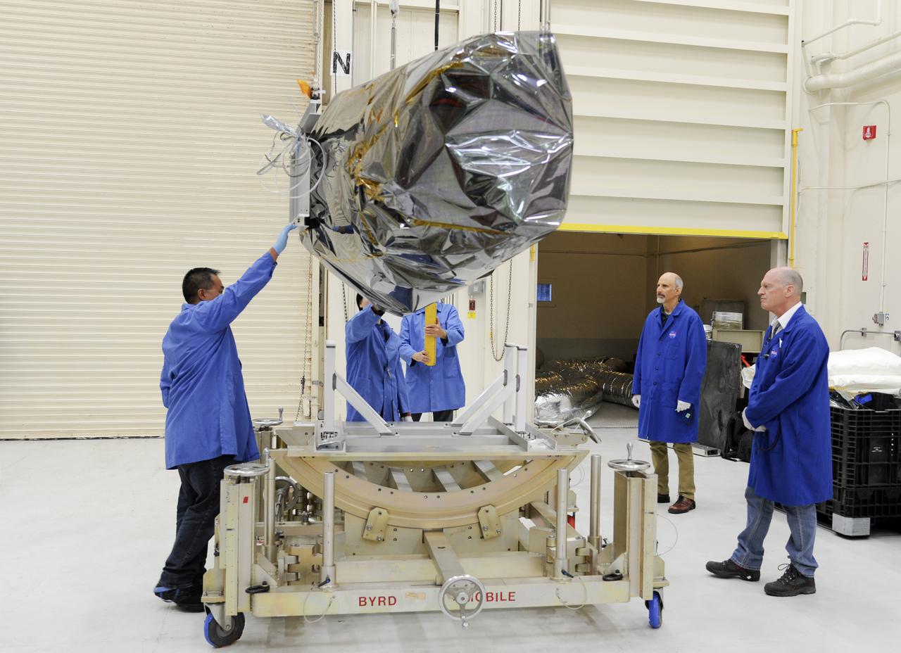 VANDENBERG AFB, Calif. – Technicians move NASA's IRIS spacecraft at Vandenberg where the spacecraft will be readied for launch aboard an Orbital Sciences Pegasus XL rocket. IRIS is short for Interface Region Imaging Spectrograph and the spacecraft's mission will improve our understanding of how heat and energy move through the deepest levels of the sun’s atmosphere, thereby increasing our ability to forecast space weather. Photo credit: VAFB_Doug Gruber