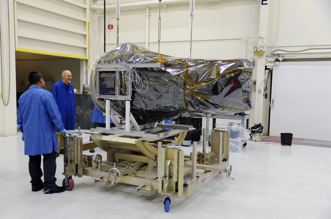 VANDENBERG AFB, Calif. – Technicians connect NASA's IRIS spacecraft to a fixture at Vandenberg where the spacecraft will be readied for launch aboard an Orbital Sciences Pegasus XL rocket. IRIS is short for Interface Region Imaging Spectrograph and the spacecraft's mission will improve our understanding of how heat and energy move through the deepest levels of the sun’s atmosphere, thereby increasing our ability to forecast space weather. Photo credit: VAFB_Doug Gruber
