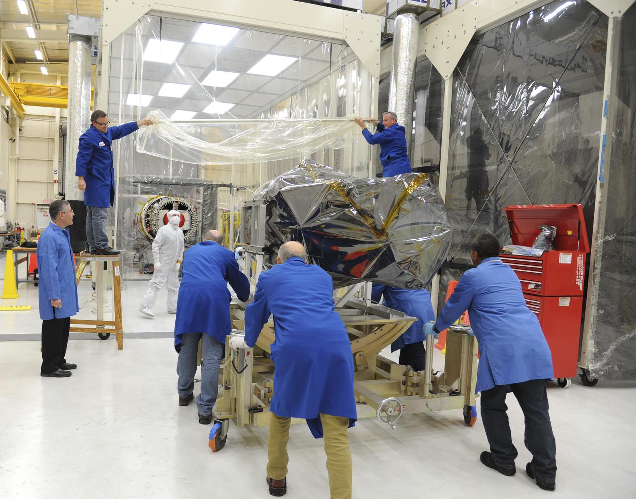 VANDENBERG AFB, Calif. – Technicians move NASA's IRIS spacecraft into a clean room at Vandenberg where the spacecraft will be readied for launch aboard an Orbital Sciences Pegasus XL rocket. IRIS is short for Interface Region Imaging Spectrograph and the spacecraft's mission will improve our understanding of how heat and energy move through the deepest levels of the sun’s atmosphere, thereby increasing our ability to forecast space weather. Photo credit: VAFB_Doug Gruber