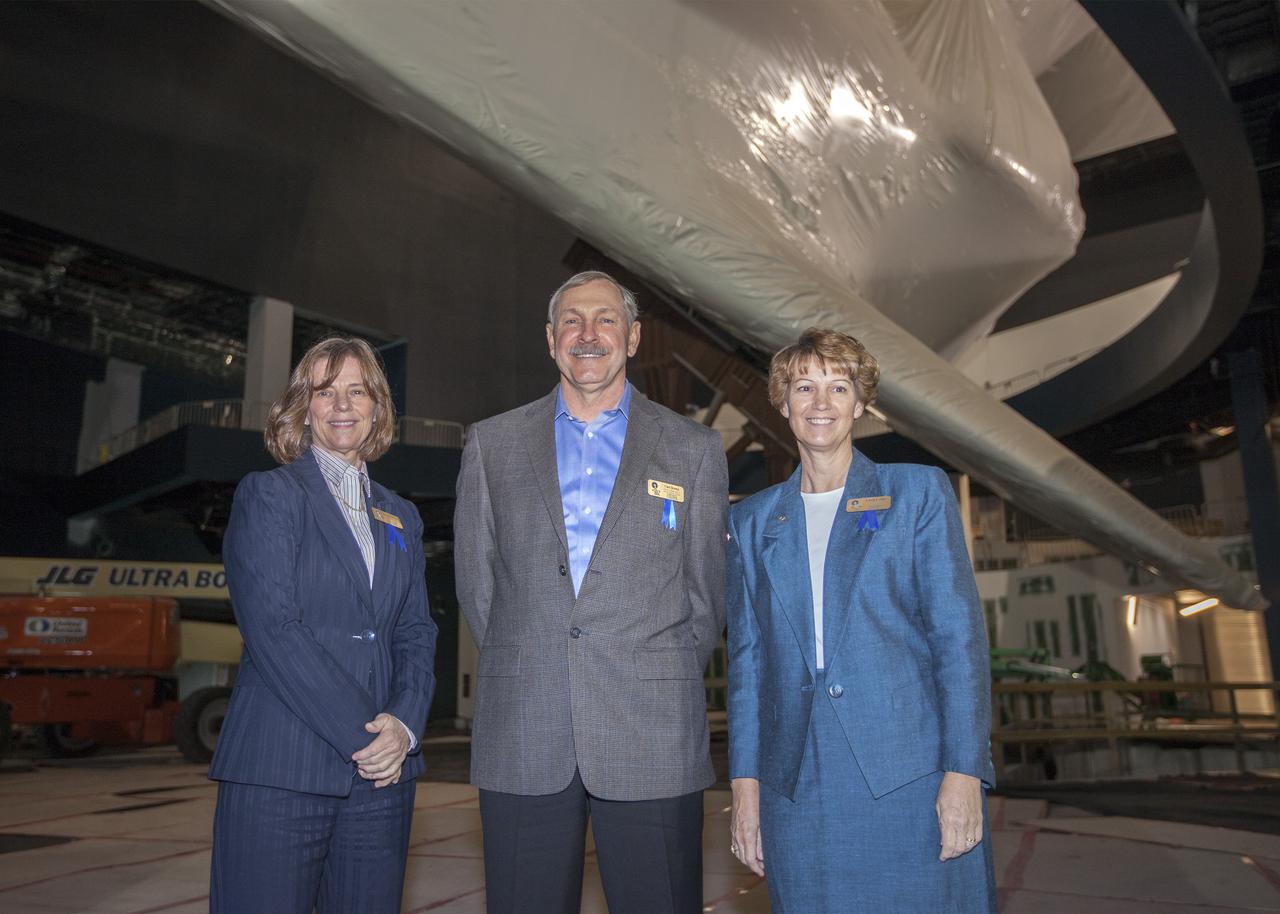 CAPE CANAVERAL, Fla. – At NASA’s Kennedy Space Center Visitor Complex in Florida, space shuttle astronauts, from the left, Bonnie Dunbar, Curt Brown and Eileen Collins stand together after being inducted into the U.S. Astronaut Hall of Fame. They are standing under the space shuttle Atlantis in the facility where it will be displayed beginning June 29. The shuttle is currently protected by plastic wrap as constitution contuse. This induction is the twelfth group of space shuttle astronauts named to the AHOF, and the first time two women are inducted at the same time. The year’s inductees were selected by a committee of current Hall of Fame astronauts, former NASA officials, historians and journalists. The selection process is administered by the Astronaut Scholarship Foundation. For more on the U.S. Astronaut Hall of Fame, go to http:__www.kennedyspacecenter.com_astronaut-hall-of-fame.aspx For more on the Astronaut Scholarship Foundation, go to http:__astronautscholarship.org_ Photo credit: NASA_ Kim Shiflett