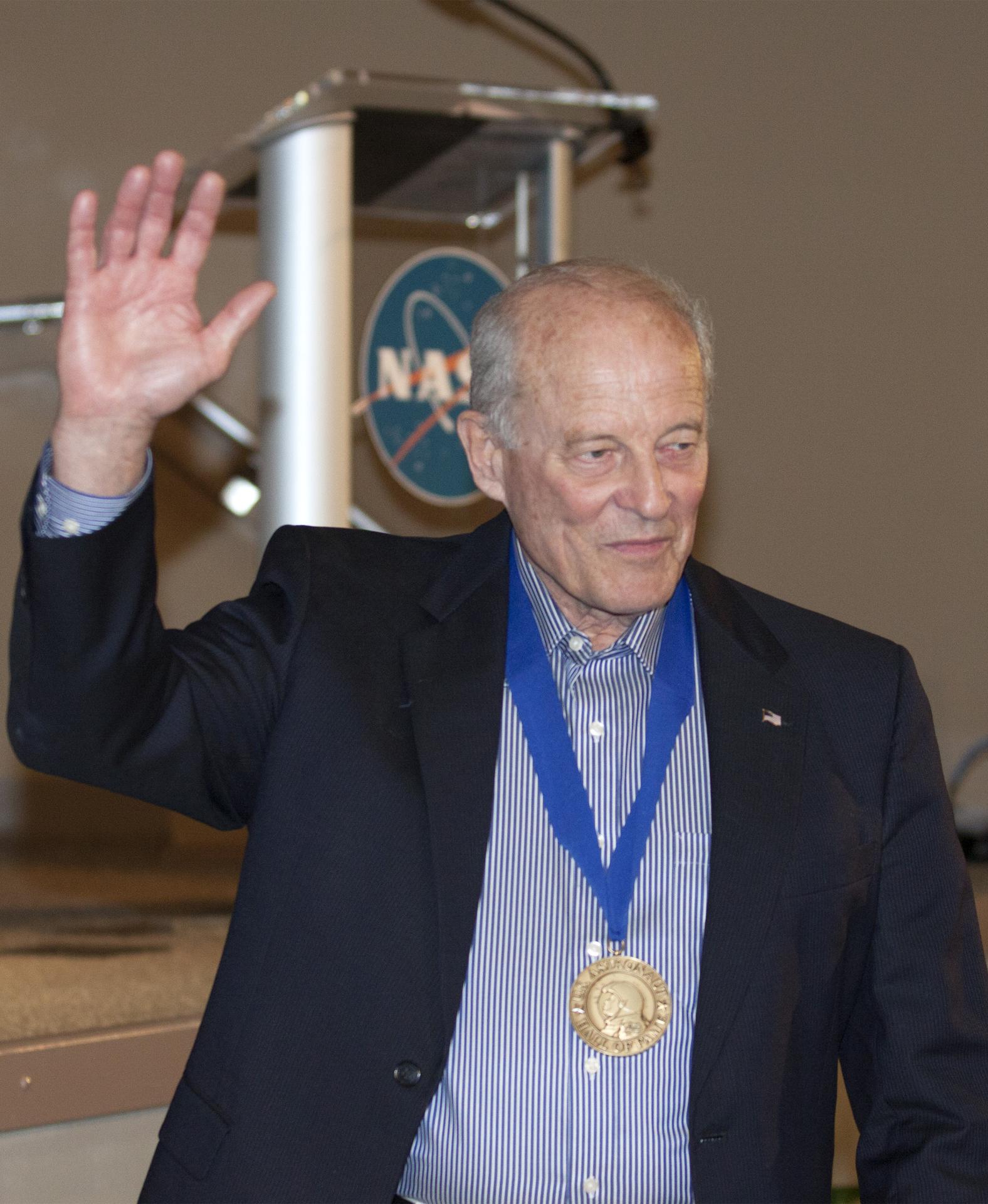 Jack Lousma wears a medal and waves to visitors