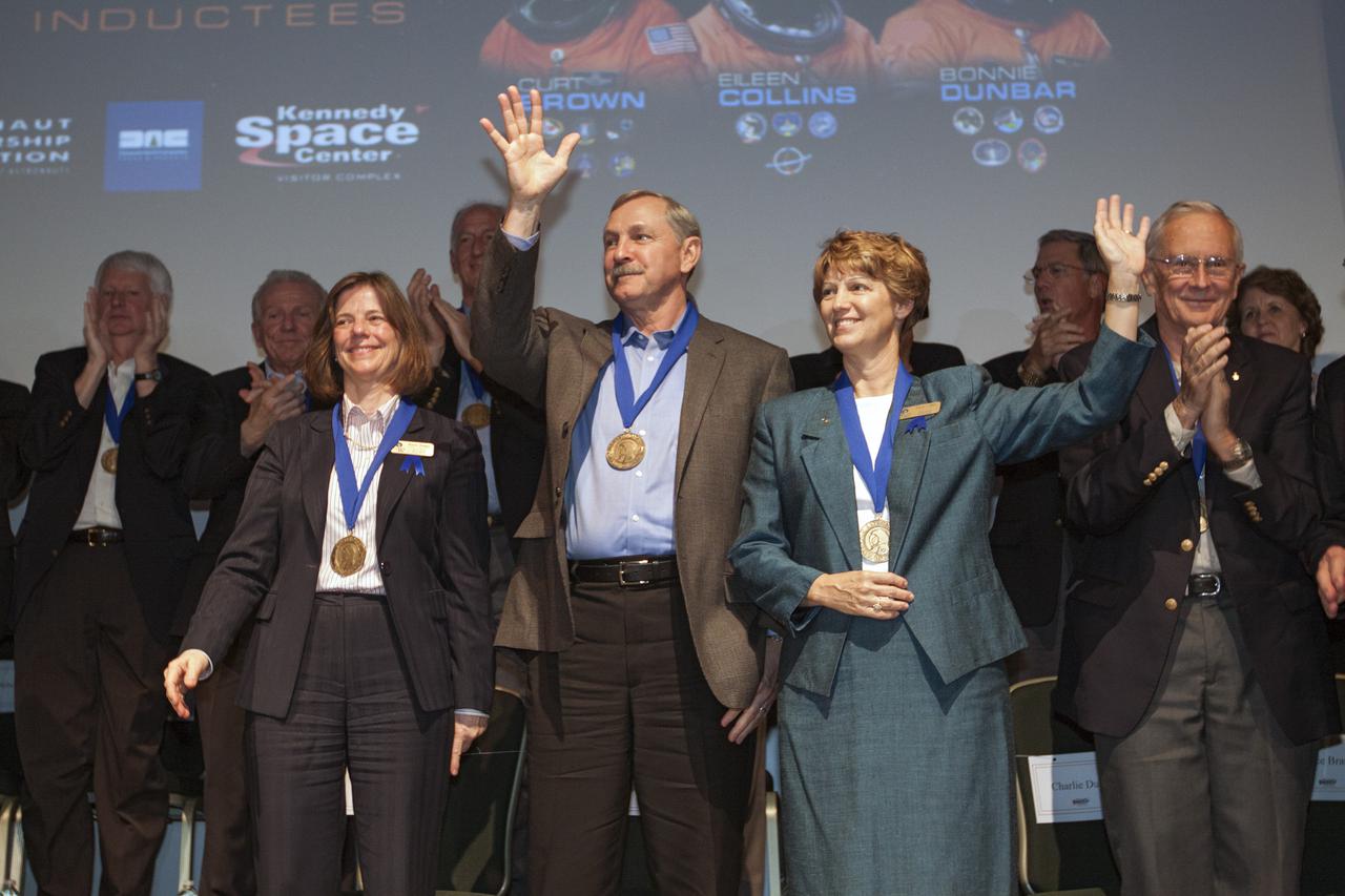 CAPE CANAVERAL, Fla. – At NASA’s Kennedy Space Center Visitor Complex in Florida, space shuttle astronauts, from the left, Bonnie Dunbar, Curt Brown and Eileen Collins stand together after being inducted into the U.S. Astronaut Hall of Fame. This induction is the twelfth group of space shuttle astronauts named to the AHOF, and the first time two women are inducted at the same time. The year’s inductees were selected by a committee of current Hall of Fame astronauts, former NASA officials, historians and journalists. The selection process is administered by the Astronaut Scholarship Foundation. For more on the U.S. Astronaut Hall of Fame, go to http:__www.kennedyspacecenter.com_astronaut-hall-of-fame.aspx For more on the Astronaut Scholarship Foundation, go to http:__astronautscholarship.org_ Photo credit: NASA_ Kim Shiflett