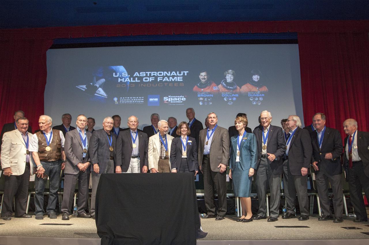 CAPE CANAVERAL, Fla. – At NASA’s Kennedy Space Center Visitor Complex in Florida, members of the U.S. Astronaut Hall of Fame stand together after the 2013 U.S. Astronaut Hall of Fame induction ceremony. Space shuttle astronauts Bonnie Dunbar, Curt Brown and Eileen Collins were inducted into the U.S. Astronaut Hall of Fame Class of 2013. This induction is the twelfth group of space shuttle astronauts named to the AHOF, and the first time two women are inducted at the same time. The year’s inductees were selected by a committee of current Hall of Fame astronauts, former NASA officials, historians and journalists. The selection process is administered by the Astronaut Scholarship Foundation. For more on the U.S. Astronaut Hall of Fame, go to http:__www.kennedyspacecenter.com_astronaut-hall-of-fame.aspx For more on the Astronaut Scholarship Foundation, go to http:__astronautscholarship.org_ Photo credit: NASA_ Kim Shiflett
