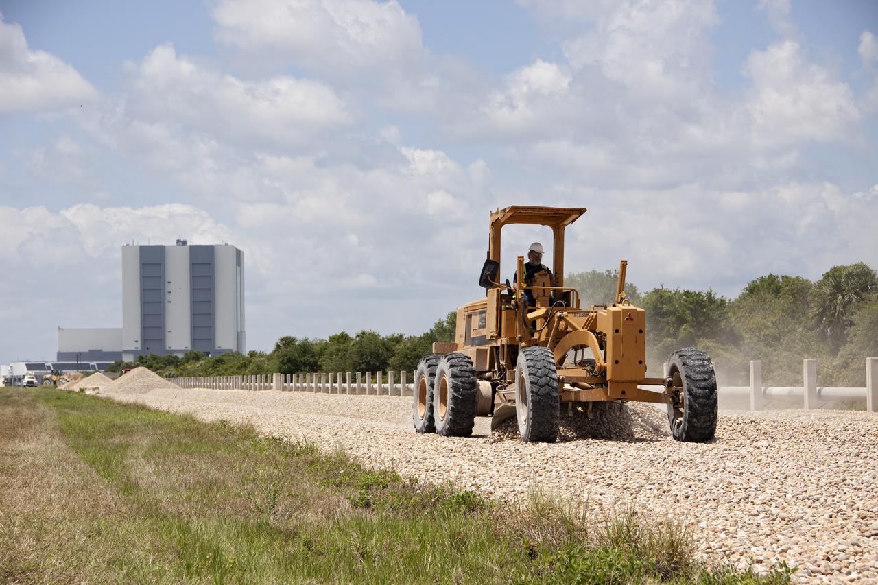 CAPE CANAVERAL, Fla. – At NASA’s Kennedy Space Center in Florida, a road-grader resurfaces a section of the crawlerway leading from the Vehicle Assembly Building VAB to the launch pads.   The Ground Systems Development and Operations GSDO Program office at Kennedy is working to upgrade the two 40-foot-wide pathways the crawler-transporter will travel as it transports launch vehicles such as NASA's Space Launch System SLS rocket from the VAB to the launch pad. For more: http:__www.nasa.gov_exploration_systems_ground_crawlerway_upgrades.html Photo credit: NASA_Jim Grossman