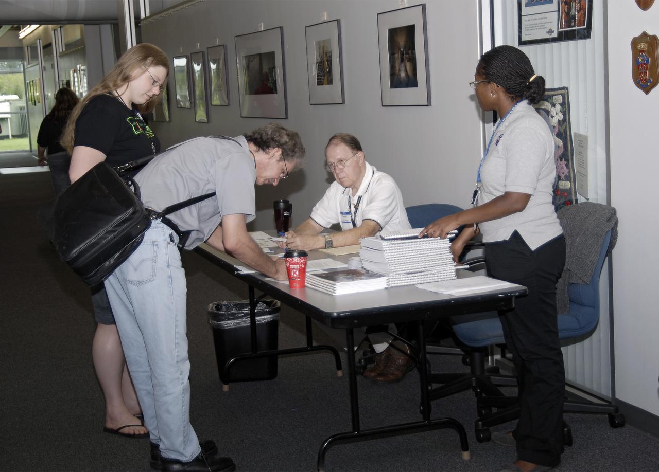 CAPE CANAVERAL, Fla. – Participants sign in at the Center for Space Education at the Kennedy Space Center Visitor Complex in Florida for the 2013 International Space Apps Challenge. . During the worldwide two-day challenge, more than 9,000 people and 484 organizations came together in 83 cities across 44 countries, as well as online, to develop new ways of solving challenges that NASA faces. At Kennedy, four teams brainstormed ideas with subject matter experts and others and worked nearly 32 hours straight to present their concepts to a panel of three technical and non-technical judges. Challenges tackled at Kennedy were: Deployable Greenhouse, Kennedy Space Center 2040, Seven Minutes of Science, and Moonville – Lunar Industry Game. Photo credit: NASA_Charisse Nahser
