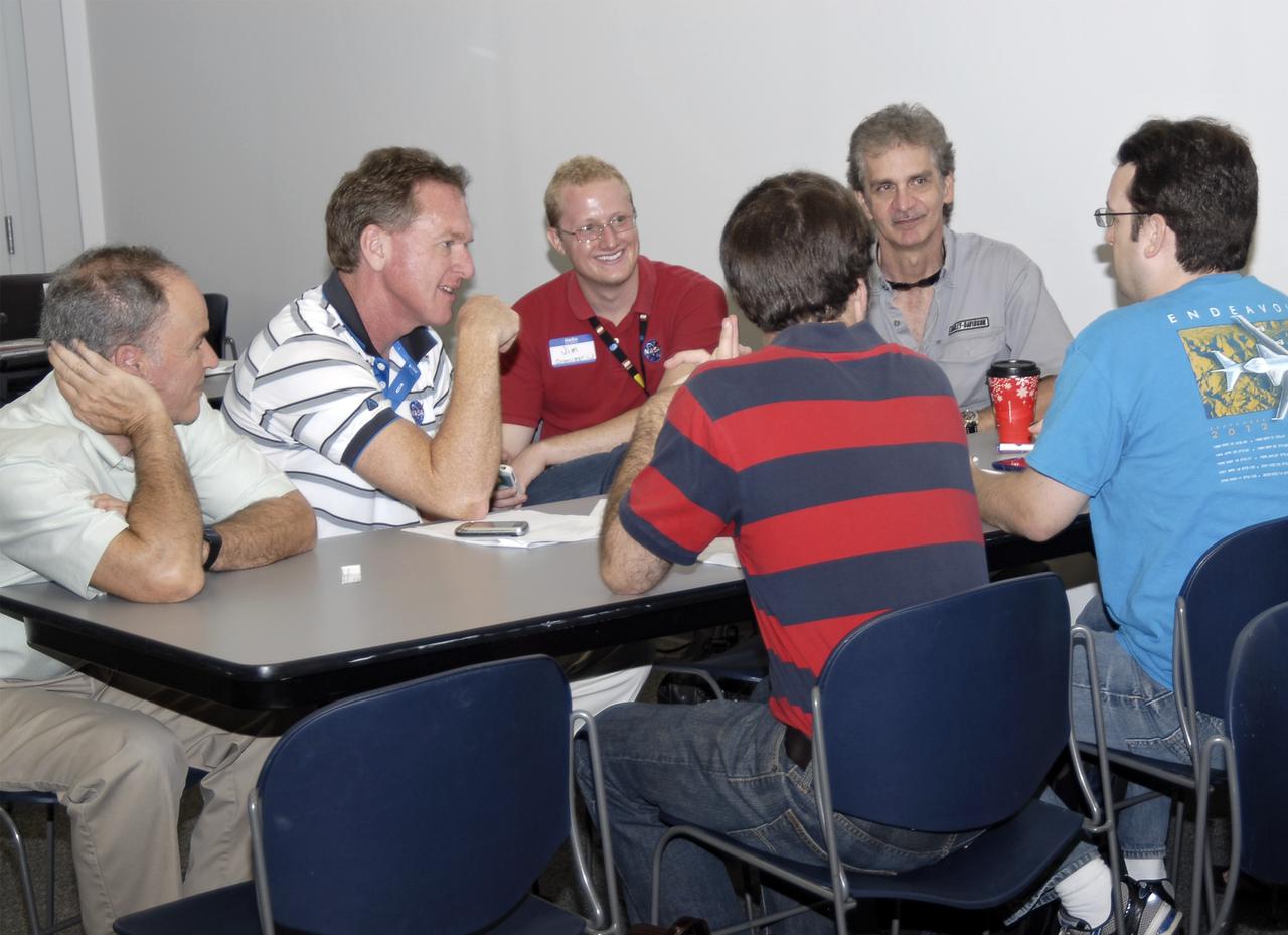 CAPE CANAVERAL, Fla. – Subject matter experts, event volunteers and participants discuss ideas during the 2013 International Space Apps Challenge at the Center for Space Education at the Kennedy Space Center Visitor Complex in Florida. From left, are Dr. Ray Wheeler, NASA subject matter expert Mike Bolger, Kennedy’s Information Technology director Jim Wood, event volunteer challenge participants Pat Starace and Mike King from Orlando and David Thorpe in Kennedy’s Center Planning and Development Directorate.  During the worldwide two-day challenge, more than 9,000 people and 484 organizations came together in 83 cities across 44 countries, as well as online, to develop new ways of solving challenges that NASA faces. At Kennedy, four teams brainstormed ideas with subject matter experts and others and worked nearly 32 hours straight to present their concepts to a panel of three technical and non-technical judges. Challenges tackled at Kennedy were: Deployable Greenhouse, Kennedy Space Center 2040, Seven Minutes of Science, and Moonville – Lunar Industry Game. Photo credit: NASA_Charisse Nahser