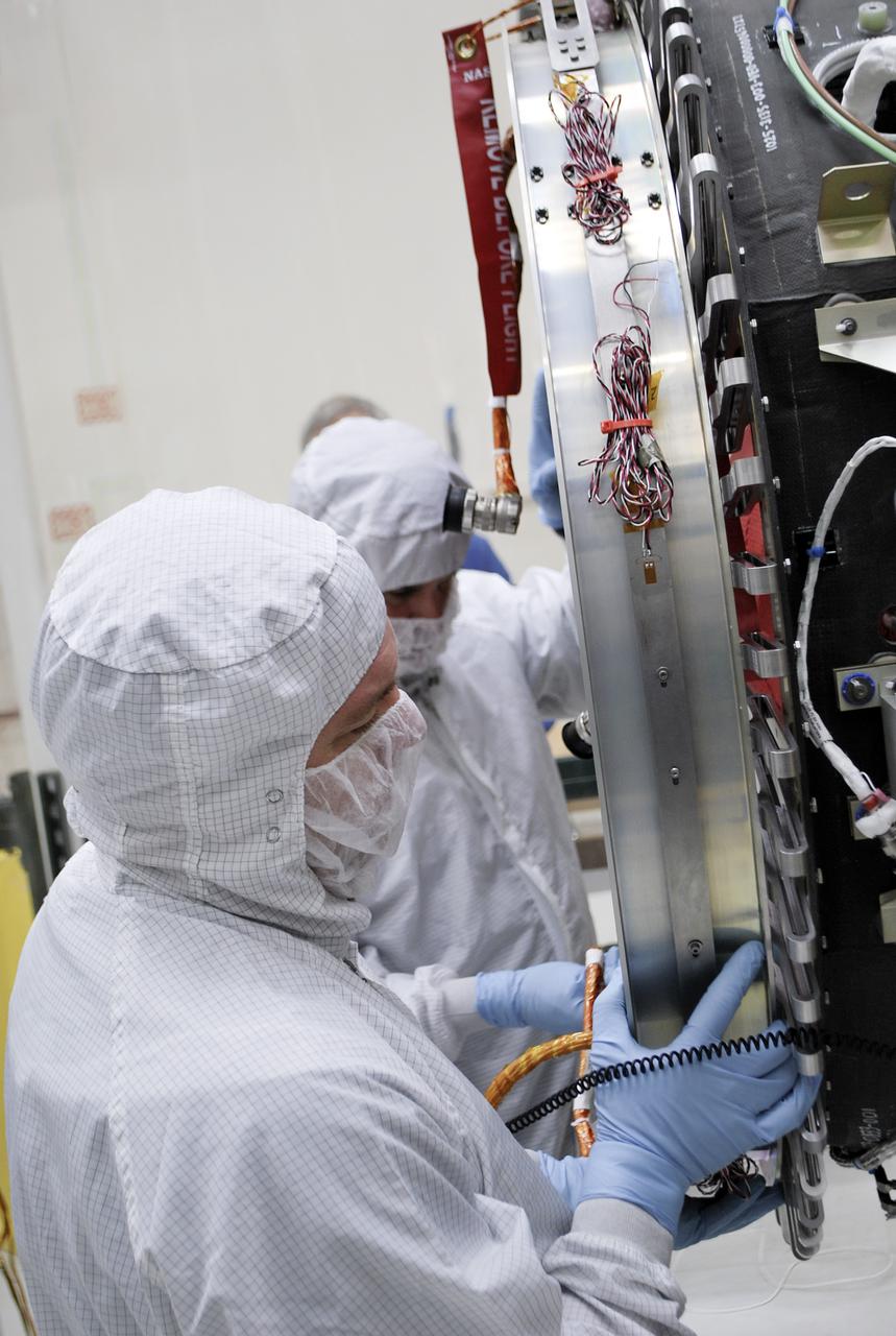 VANDENBERG AFB, Calif. – Technicians test fit the separation system that will push NASA's IRIS spacecraft away from an Orbital Pegasus XL rocket when IRIS reaches its proper orbit after launch. IRIS is short for Interface Region Imaging Spectrograph and the spacecraft's mission will improve our understanding of how heat and energy move through the deepest levels of the sun’s atmosphere, thereby increasing our ability to forecast space weather. Photo credit: VAFB_Randy Beaudoin