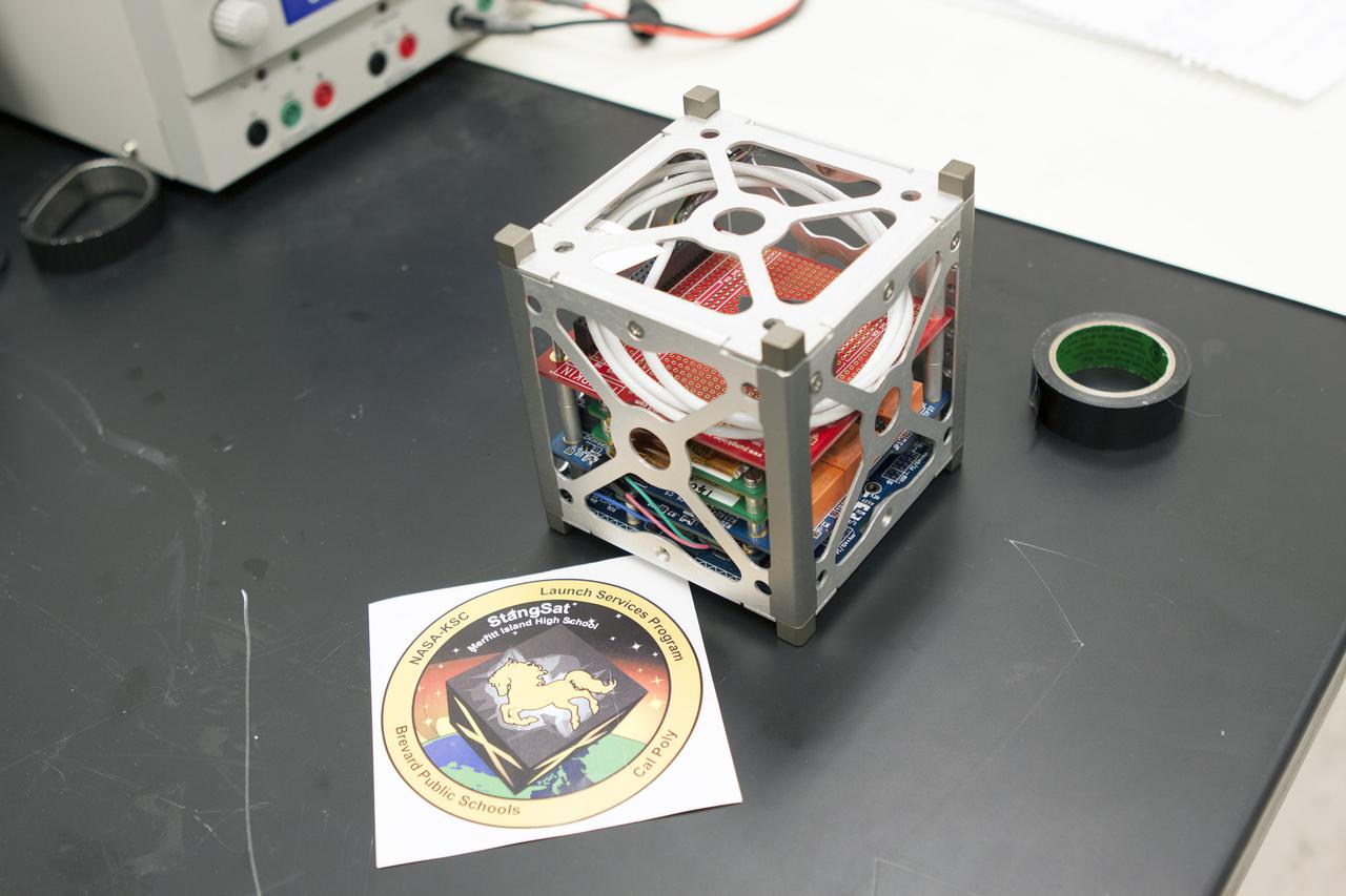 CAPE CANAVERAL, Fla. – A prototype of the StangSat undergoes testing at Kennedy Space Center before final assembly. The satellite is a small cube measuring 10 inches on all sides and will be launched on a rocket that will carry it on a suborbital mission in Mojave, Calif. Photo credit: NASA_Jim Grossmann