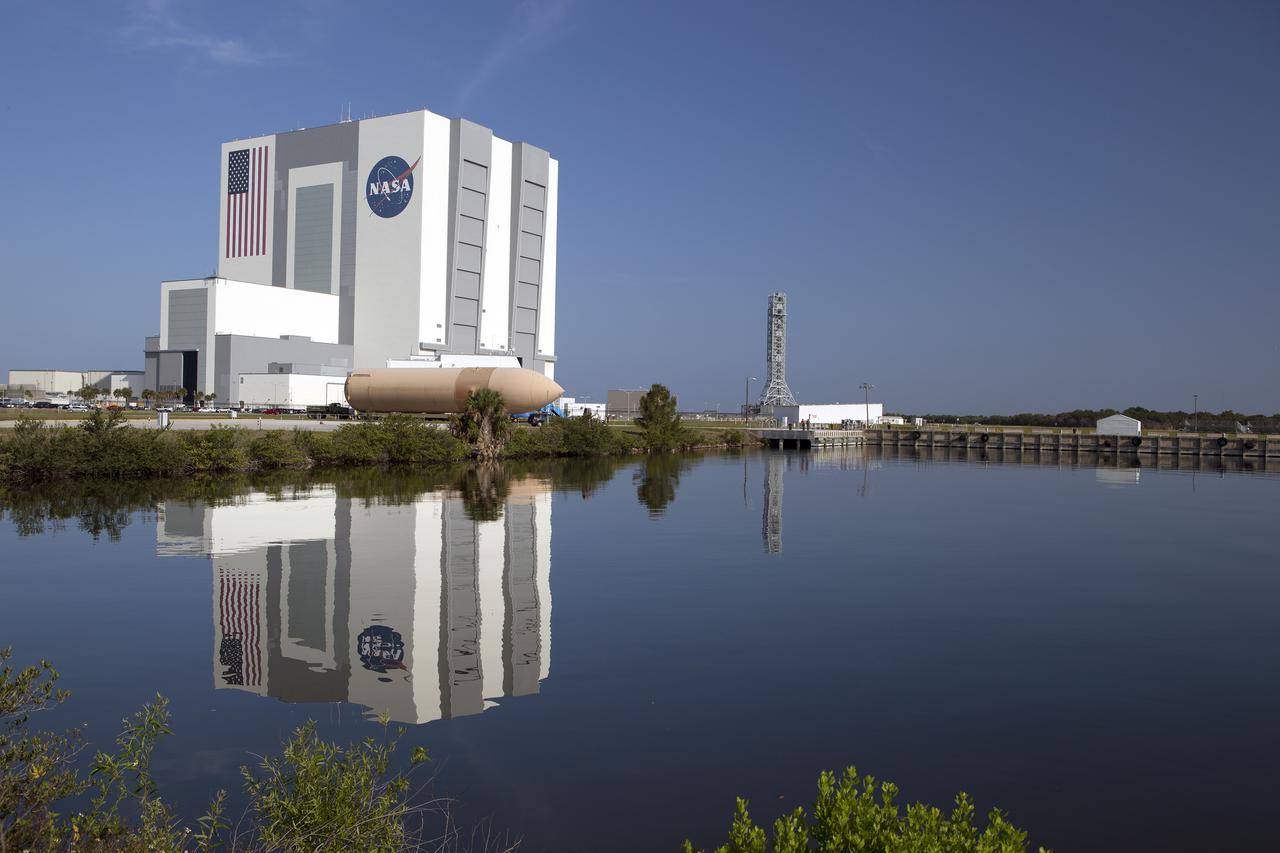 CAPE CANAVERAL, Fla. – An orange flight test article space shuttle external fuel tank, or ET, awaits transport from NASA's Kennedy Space Center in Florida to the Wings of Dreams Aviation Museum located at Keystone Heights Airport in North Central Florida. Weighing in at 58,000 pounds unfueled and standing more than 15-stories tall, the ET was referred to as the 'backbone' of the space shuttle. Its job was to hold about 535,000 gallons of super-cold liquid hydrogen and liquid oxygen. It also absorbed the thrust loads produced at launch by the orbiter and the solid rocket boosters, or SRBs. Also joining the ET at Wings of Dreams is an ET transporter, the crew transport vehicle, crew hatch access vehicle, SRB aft skirt and SRB frustum.  Thousands of unique space shuttle era artifacts are being allocated to facilities across the country for their new missions to educate and inspire America's next generation of explorers. Photo credit: NASA_Dimitri Gerondidakis