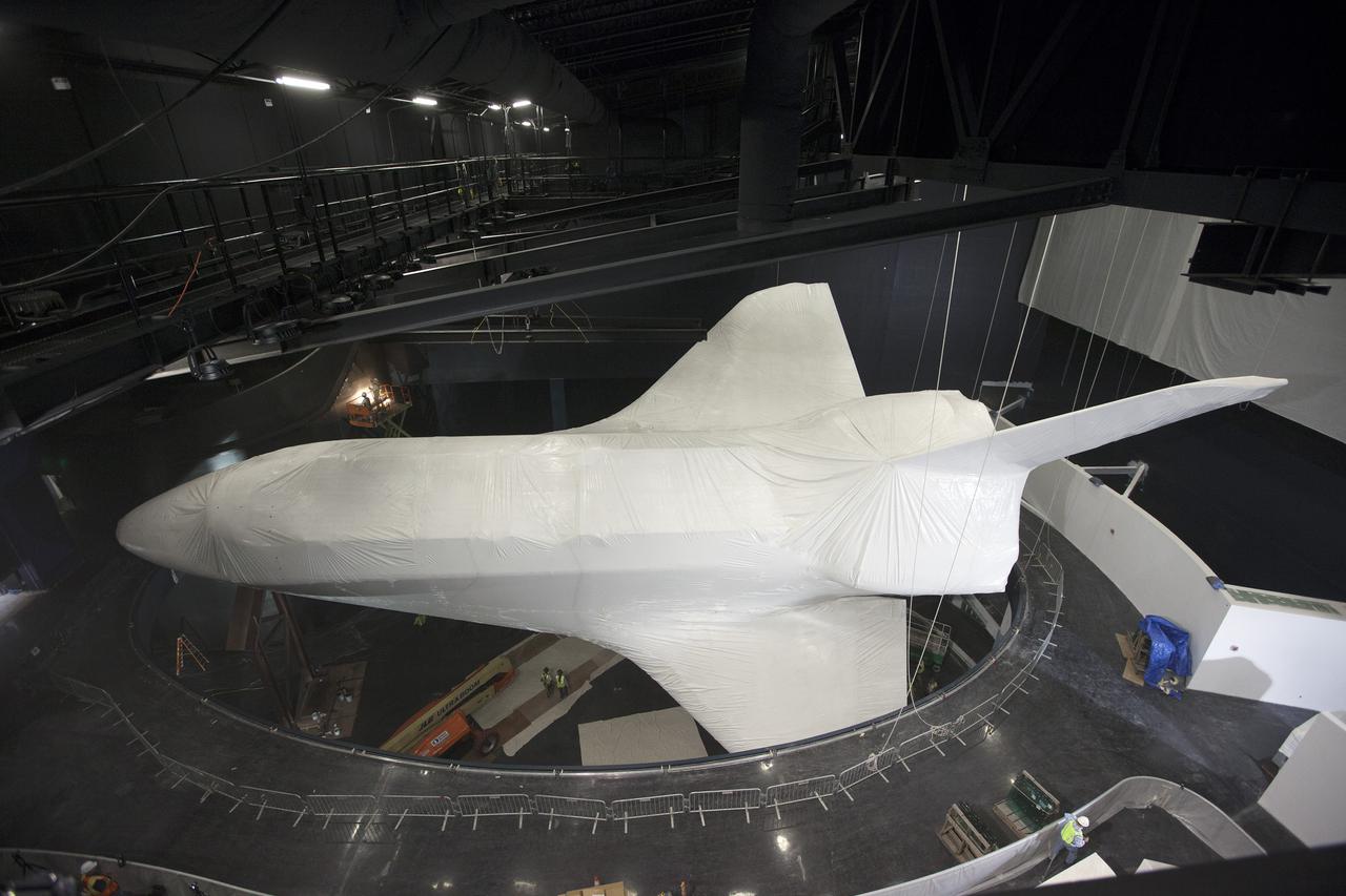 CAPE CANAVERAL, Fla. -- At the Kennedy Space Center Visitor Complex in Florida, construction crews prepare to remove 16,000 square feet of plastic shrink-wrap from the space shuttle Atlantis. The spacecraft was enclosed in the plastic shrink-wrap since November of last year to protect the artifact from dust and debris during construction of the 90,000-square-foot facility.   Last November, the space shuttle Atlantis made its historic final journey to its new home, traveling 10 miles from the Kennedy Space Center's Vehicle Assembly Building to the spaceport's visitor complex. The new $100 million 'Space Shuttle Atlantis' facility will include interactive exhibits that tell the story of the 30-year Space Shuttle Program and highlights the future of space exploration. The 'Space Shuttle Atlantis' exhibit scheduled to open June 29, 2013.Photo credit: NASA_Kim Shiflett