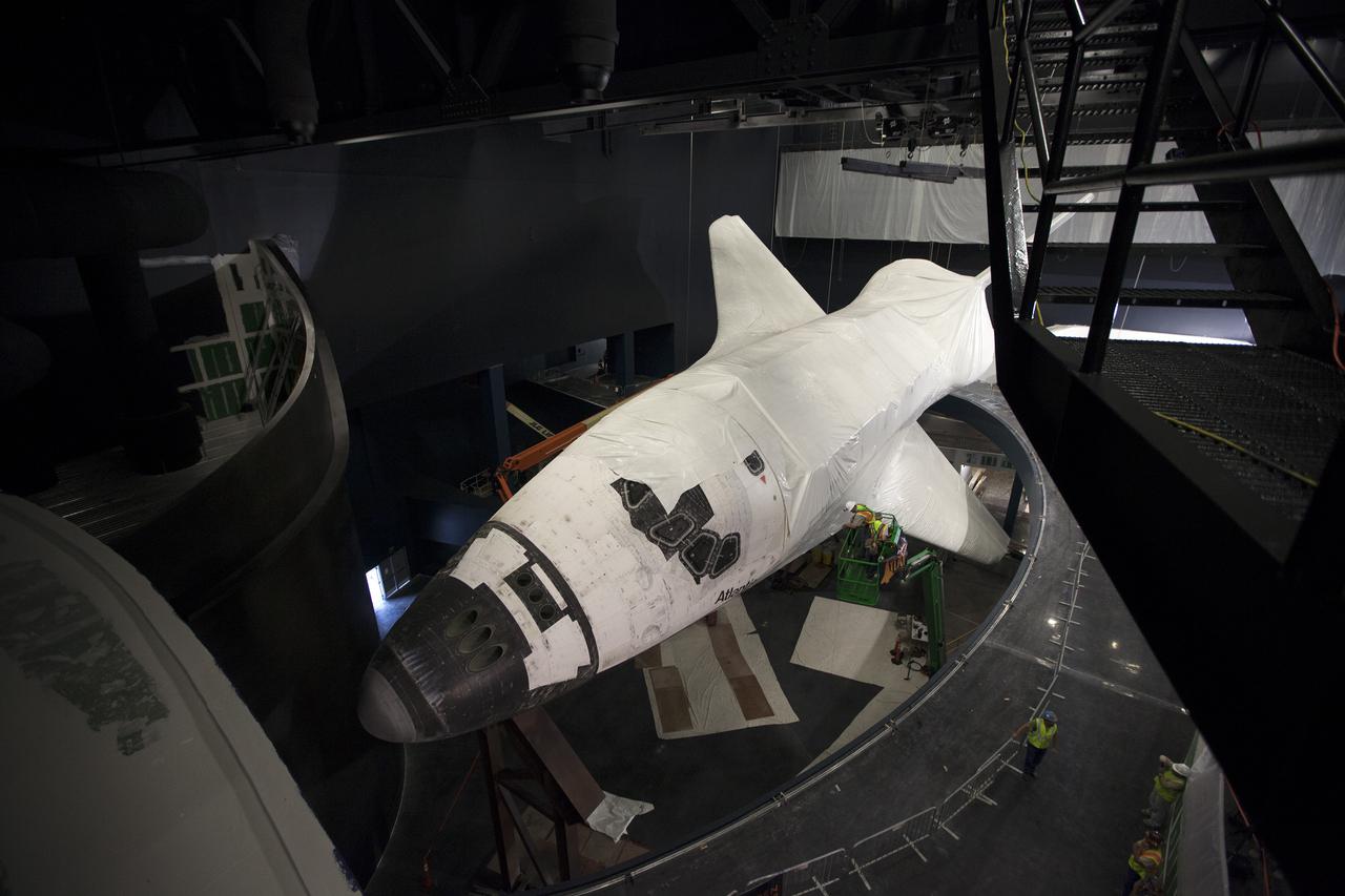 CAPE CANAVERAL, Fla. -- At the Kennedy Space Center Visitor Complex in Florida, the nose cap and part of the forward reaction control system is uncovered as construction crews begin removing 16,000 square feet of plastic shrink-wrap from the space shuttle Atlantis. The spacecraft was enclosed in the plastic shrink-wrap since November of last year to protect the artifact from dust and debris during construction of the 90,000-square-foot facility. Last November, the space shuttle Atlantis made its historic final journey to its new home, traveling 10 miles from the Kennedy Space Center's Vehicle Assembly Building to the spaceport's visitor complex. The new $100 million 'Space Shuttle Atlantis' facility will include interactive exhibits that tell the story of the 30-year Space Shuttle Program and highlights the future of space exploration. The 'Space Shuttle Atlantis' exhibit scheduled to open June 29, 2013.Photo credit: NASA_Kim Shiflett
