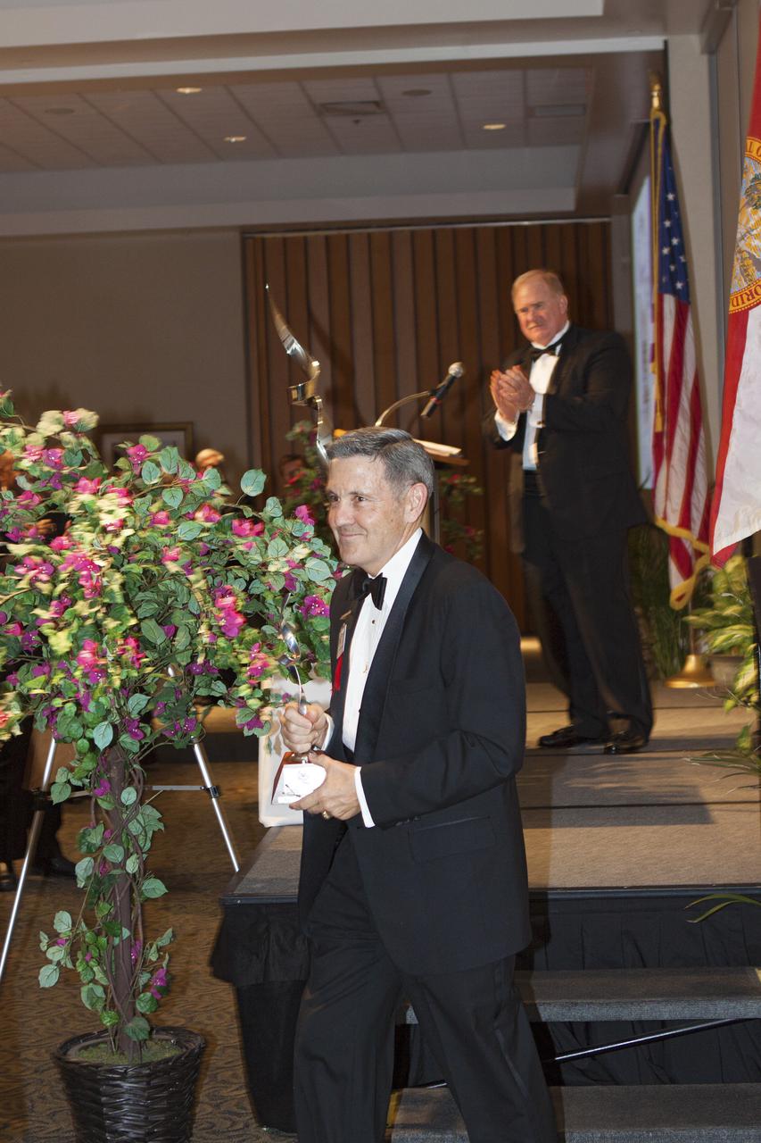 CAPE CANAVERAL, Fla. – At NASA’s Kennedy Space Center Visitor Complex in Florida, National Space Club Florida Committee Chairman Jim McCarthy, at the podium, has just presented the prestigious Dr. Kurt H. Debus Award to Kennedy's director, Bob Cabana. A former U.S. Marine Corps aviator and NASA astronaut, Cabana was honored at the gala Debus Award Dinner. Named for the spaceport’s first director, the Debus Award was created to recognize significant achievements and contributions made in Florida to American aerospace efforts. The Debus Award was created by the space club's Florida committee to recognize significant achievements and contributions made in Florida to American aerospace efforts. Photo credit: NASA_Jim Grossmann