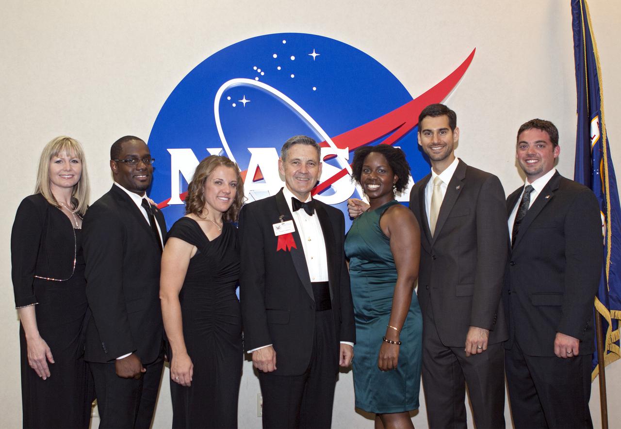 CAPE CANAVERAL, Fla. – At NASA’s Kennedy Space Center Visitor Complex in Florida, center director Bob Cabana poses with current and former interns. From the left are Joy Burkey, Robert Hubbard, Carla Koch, Cabana, LaKeesha Flowers, Michael Miller and Michael Masters.   A former U.S. Marine Corps aviator and NASA astronaut, Cabana was honored at the gala Debus Award Dinner. Named for the spaceport’s first director, the Debus Award was created to recognize significant achievements and contributions made in Florida to American aerospace efforts. The Debus Award was created by the space club's Florida committee to recognize significant achievements and contributions made in Florida to American aerospace efforts. Photo credit: NASA_Jim Grossmann