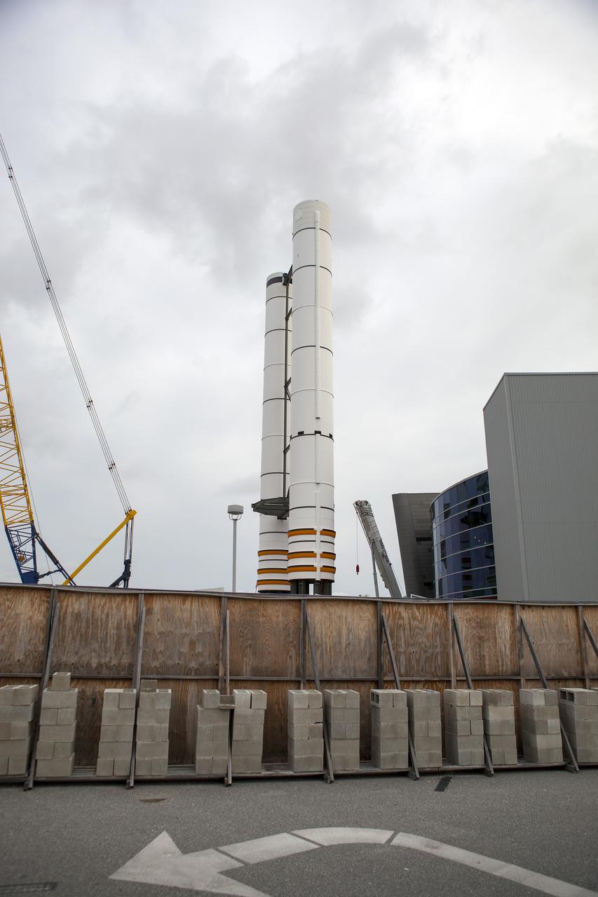 CAPE CANAVERAL, Fla. – A pair of replica space shuttle solid rocket boosters stand at the entry of the space shuttle Atlantis attraction under construction at the Kennedy Space Center Visitor Complex. Workers will use cranes to place the nose cones atop each of the model boosters. The building at right houses the actual shuttle Atlantis. Photo credit: NASA_Dmitri Gerondidakis IRIS will open a new window of discovery by tracing the flow of energy and plasma through the chromospheres and transition region into the sun’s corona using spectrometry and imaging. IRIS fills a crucial gap in our ability to advance studies of the sun-to-Earth connection by tracing the flow of energy and plasma through the foundation of the corona and the region around the sun known as the heliosphere. Photo credit: VAFB_Randy Beaudoin