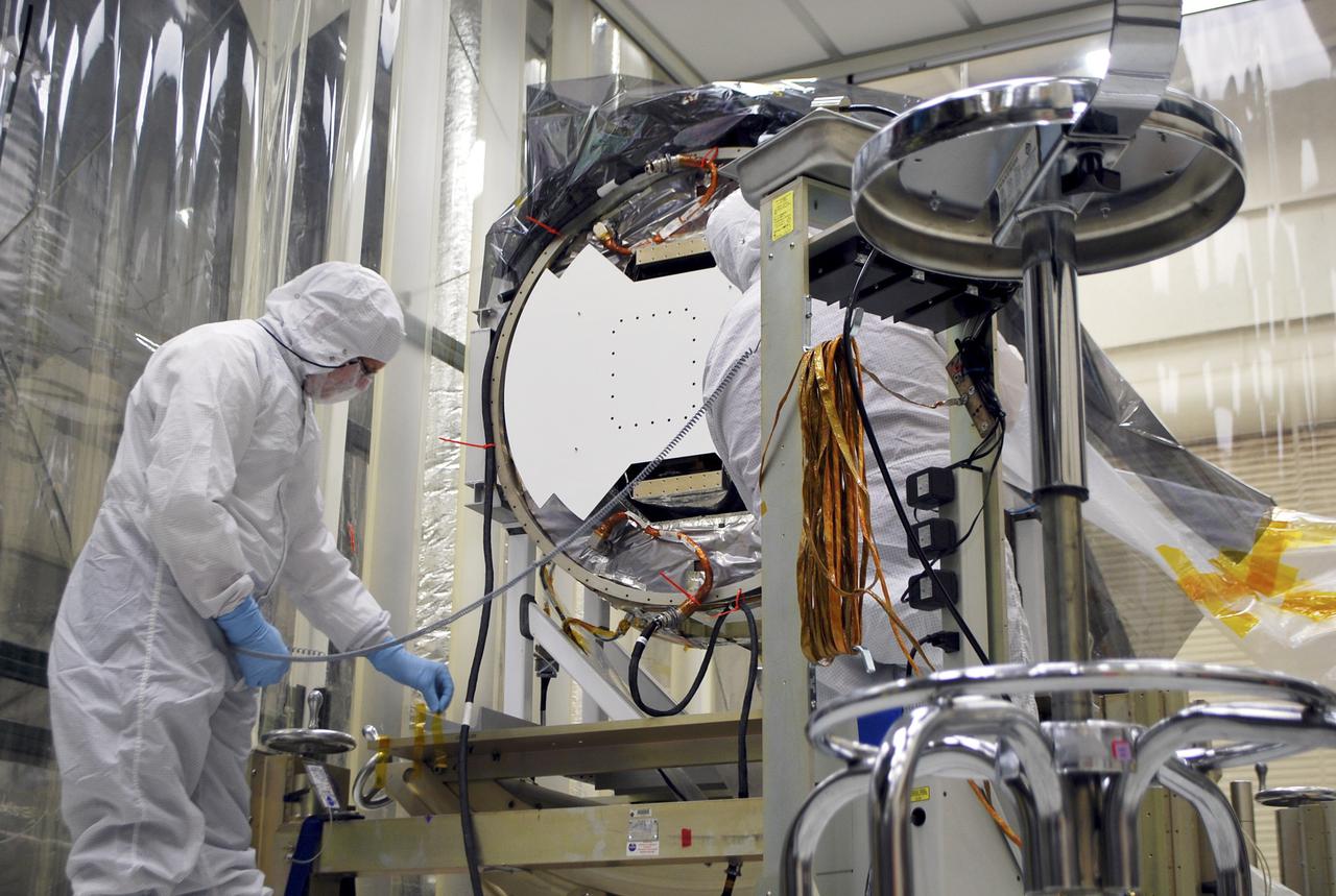 VANDENBERG AIR FORCE BASE, Calif. -- Following the first Interface Verification Test, a technician removes cables providing the electrical connections between the Interface Region Imaging Spectrograph, or IRIS, spacecraft and the Orbital Sciences Corp. Pegasus XL launch vehicle.  Completion of the test paves the way for the standalone IRIS mission simulations.          IRIS will open a new window of discovery by tracing the flow of energy and plasma through the chromospheres and transition region into the sun’s corona using spectrometry and imaging. IRIS fills a crucial gap in our ability to advance studies of the sun-to-Earth connection by tracing the flow of energy and plasma through the foundation of the corona and the region around the sun known as the heliosphere.  Photo credit: VAFB_Randy Beaudoin