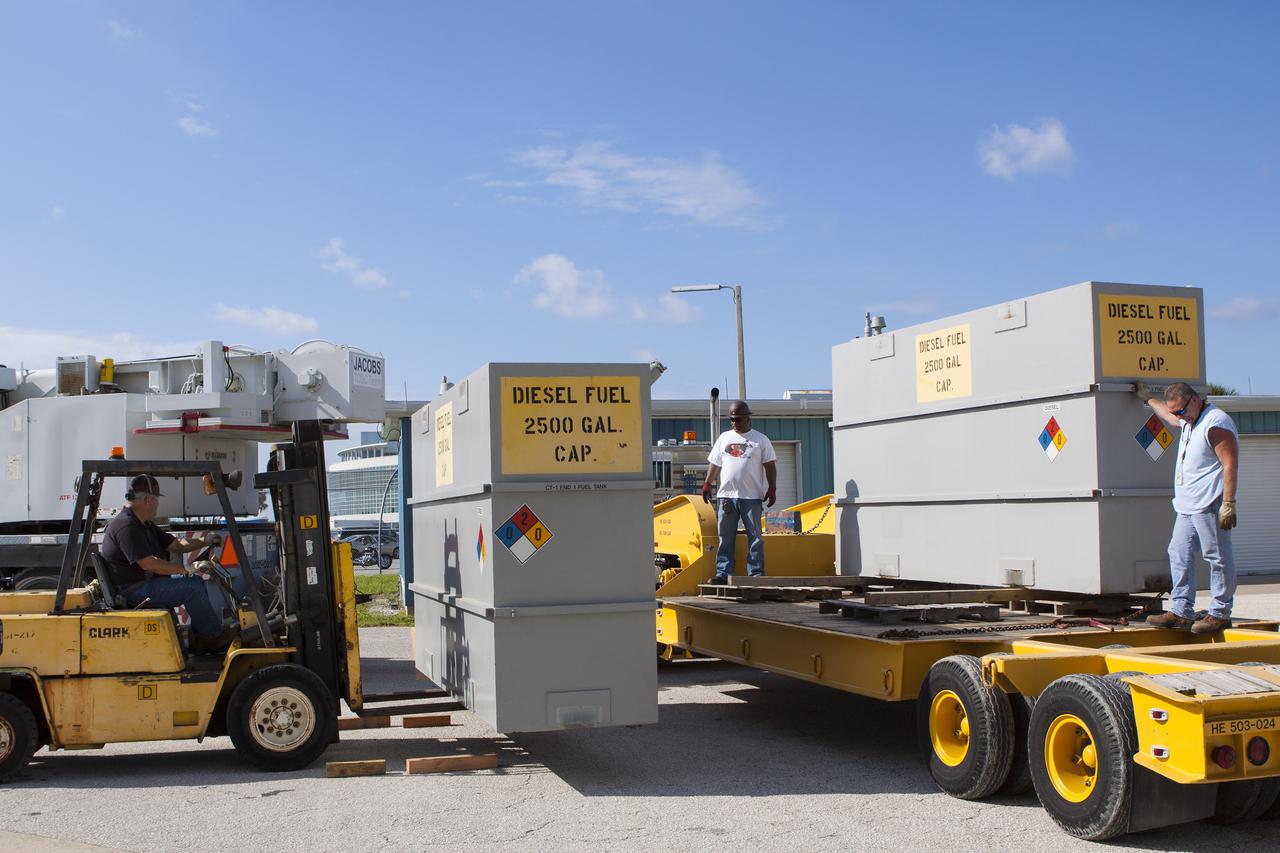 CAPE CANAVERAL, Fla. – In front of the Vehicle Assembly Building at NASA’s Kennedy Space Center in Florida, a technician uses a forklift to move a fuel tank onto a flatbed truck. Two fuel tanks were removed from crawler-transporter 1 CT-1 in high bay 3. The tanks will be sent to the Wiltech facility at Kennedy for cleaning and inspection.  Work continues in high bay 3 to upgrade CT-1 as part of its general maintenance. CT-1 could be available to carry commercial launch vehicles to the launch pad. The crawler-transporters were used to carry the mobile launcher platform and space shuttle to Launch Complex 39 for space shuttle launches for 30 years.  Photo credit: NASA_Jim Grossman