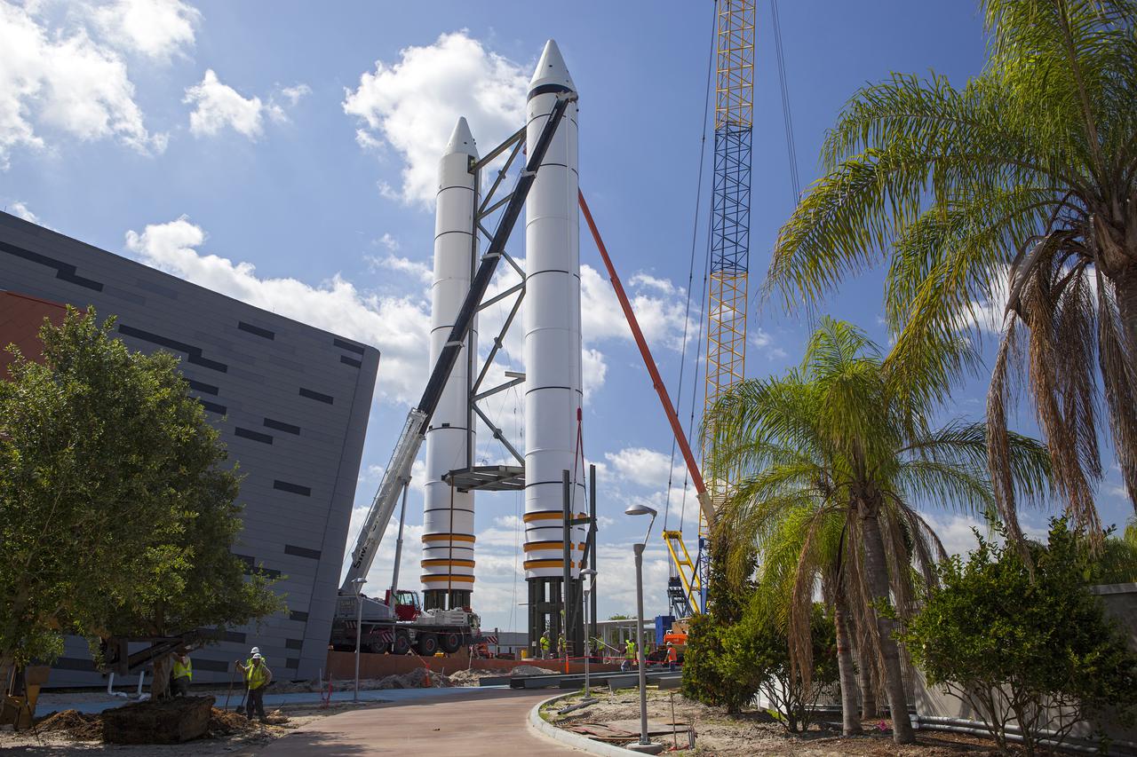 Workers connect the nosecone of a solid rocket booster replica into place at the Kennedy Space Center Visitor Complex where the Space Shuttle Atlantis exhibit and attraction is under construction. Photo credit: NASA_Dmitri Gerondidakis