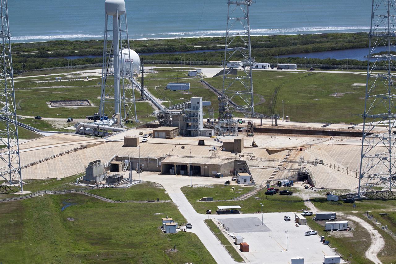CAPE CANAVERAL, Fla. – An aerial view shows construction progress at Launch Pad 39B at NASA’s Kennedy Space Center in Florida. A new elevator has been constructed on the surface of the pad and the crawlerway leading up to the surface is being repaired. Repairs also are being made to the crawler track panels and catacomb roof below on either side of the flame trench. Also in view are the water tower and the three tall lightning towers that surround the pad.  Upgrades are underway at Pad B and other facilities in the Launch Complex 39 area. The Ground Systems Development and Operations, or GSDO, Program office at Kennedy is leading the center’s transformation from a historically government-only launch complex to a spaceport that can safely handle a variety of rockets and spacecraft, including NASA’s Space Launch System. For more information about GSDO, visit: http:__go.nasa.gov_groundsystems.  Photo credit: NASA_Kim Shiflett