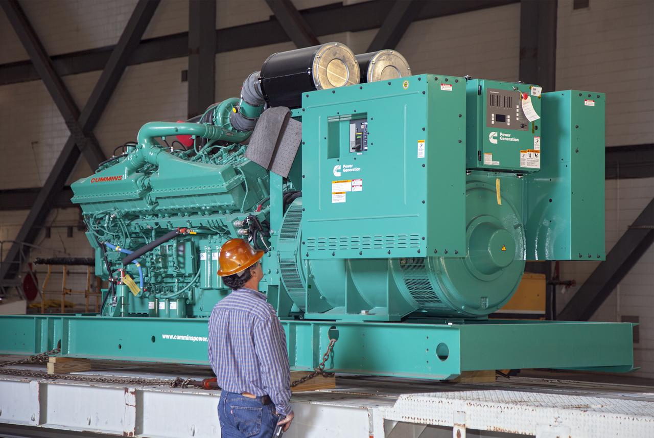 CAPE CANAVERAL, Fla. – Inside the Vehicle Assembly Building at NASA’s Kennedy Space Center in Florida, a technician inspects a new generator for installation in crawler-transporter 1, or CT-1.  Work continues in high bay 3 to upgrade CT-1 as part of its general maintenance. CT-1 could be available to carry commercial launch vehicles to the launch pad. The crawler-transporters were used to carry the mobile launcher platform and space shuttle to Launch Complex 39 for space shuttle launches for 30 years.  Photo credit: NASA_Daniel Casper