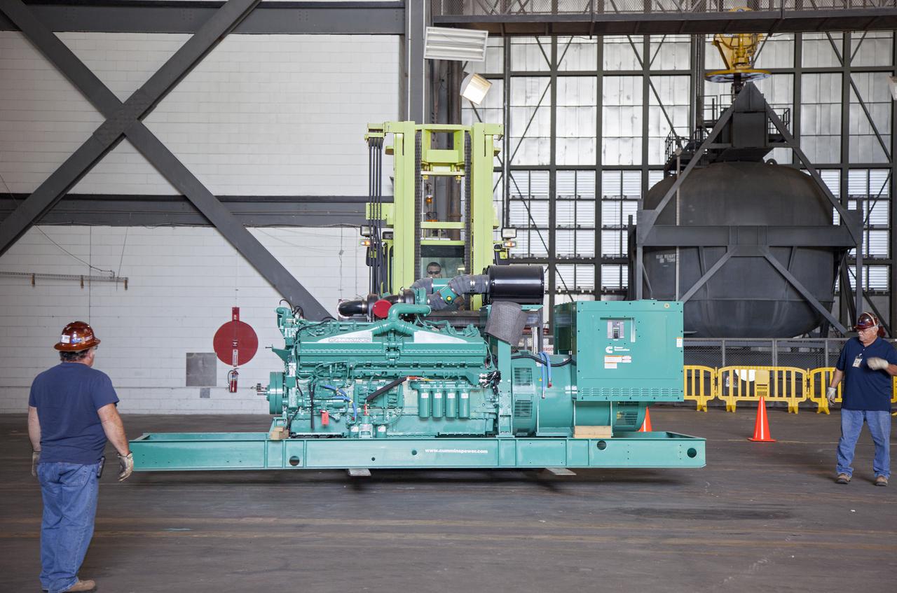 CAPE CANAVERAL, Fla. – Inside the Vehicle Assembly Building at NASA’s Kennedy Space Center in Florida, technicians prepare a new generator for installation in crawler-transporter 1, or CT-1.    Work continues in high bay 3 to upgrade CT-1 as part of its general maintenance. CT-1 could be available to carry commercial launch vehicles to the launch pad. The crawler-transporters were used to carry the mobile launcher platform and space shuttle to Launch Complex 39 for space shuttle launches for 30 years.  Photo credit: NASA_Daniel Casper