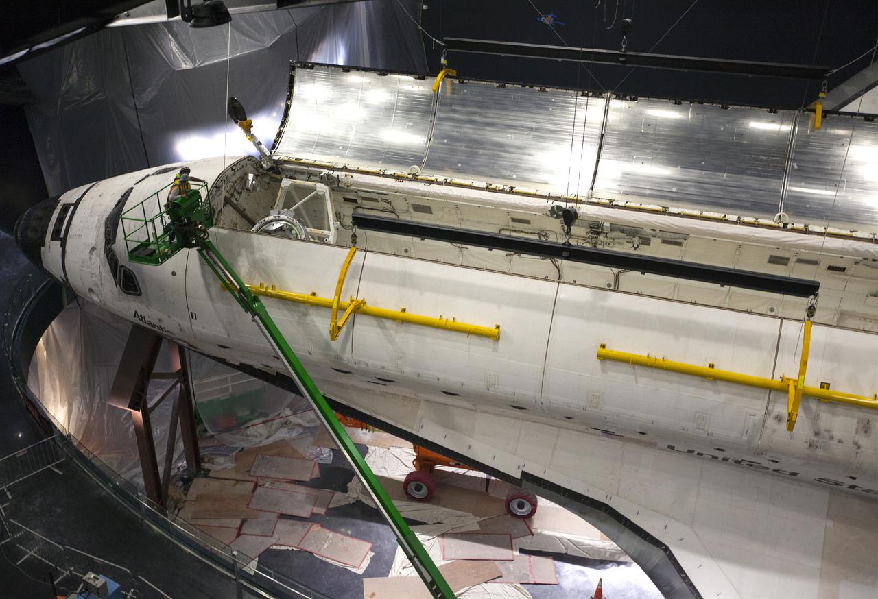CAPE CANAVERAL, Fla. – At the Kennedy Space Center Visitor Complex in Florida, technicians monitor the progress as space shuttle Atlantis’ payload bay doors are opened. Atlantis is being prepared for display in the “Space Shuttle Atlantis” exhibit, a 90,000-square-foot facility, scheduled to open June 29, 2013.  The new $100 million facility will include interactive exhibits that tell the story of the 30-year Space Shuttle Program and highlight the future of space exploration. Visitors to the exhibit will get an up close look at Atlantis with its payload bay doors open, similar to how it looked in space. Photo credit: NASA_Kim Shiflett
