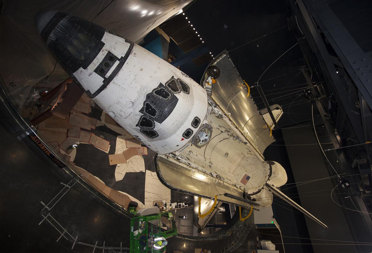 CAPE CANAVERAL, Fla. -- At the Kennedy Space Center Visitor Complex in Florida, technicians monitor the progress as space shuttle Atlantis’ payload bay doors are fully opened. Atlantis is being prepared for display in the “Space Shuttle Atlantis” exhibit, a 90,000-square-foot facility, scheduled to open June 29, 2013.  The new $100 million facility will include interactive exhibits that tell the story of the 30-year Space Shuttle Program and highlight the future of space exploration. Visitors to the exhibit will get an up close look at Atlantis with its payload bay doors open, similar to how it looked in space. Photo credit: NASA_Kim Shiflett