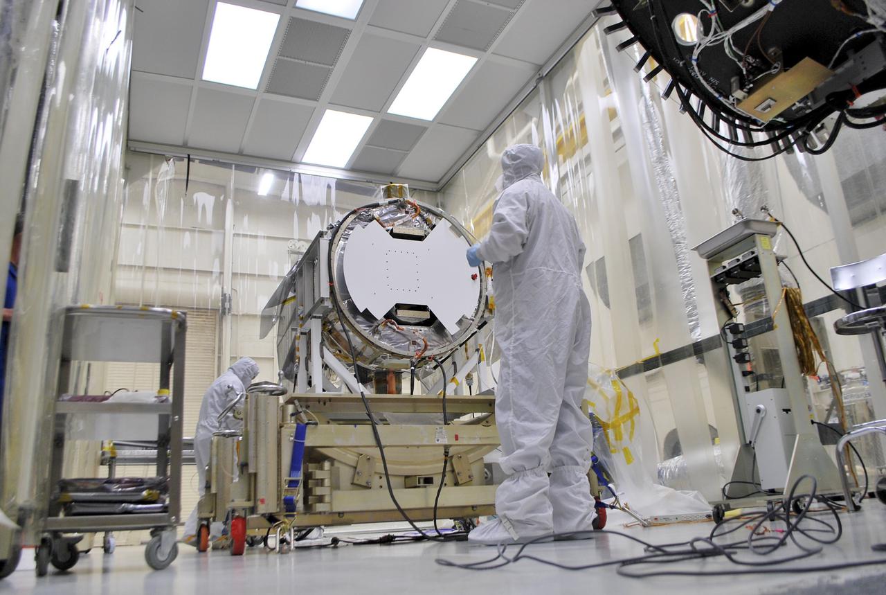 VANDENBERG AIR FORCE BASE, Calif. – At Vandenberg Air Force Base in California, technicians and engineers prepare a separation system ring that will be attached to NASA's Interface Region Imaging Spectrograph, or IRIS, spacecraft. The separation system will push IRIS away from an Orbital Pegasus XL rocket when the spacecraft reaches its proper orbit after launch.   Scheduled for launch from Vandenberg Air Force Base no earlier than June 26, 2013, IRIS will open a new window of discovery by tracing the flow of energy and plasma through the chromospheres and transition region into the sun’s corona using spectrometry and imaging. IRIS fills a crucial gap in our ability to advance studies of the sun-to-Earth connection by tracing the flow of energy and plasma through the foundation of the corona and the region around the sun known as the heliosphere. For more information, visit http:__iris.gsfc.nasa.gov Photo credit: NASA_Randy Beaudoin