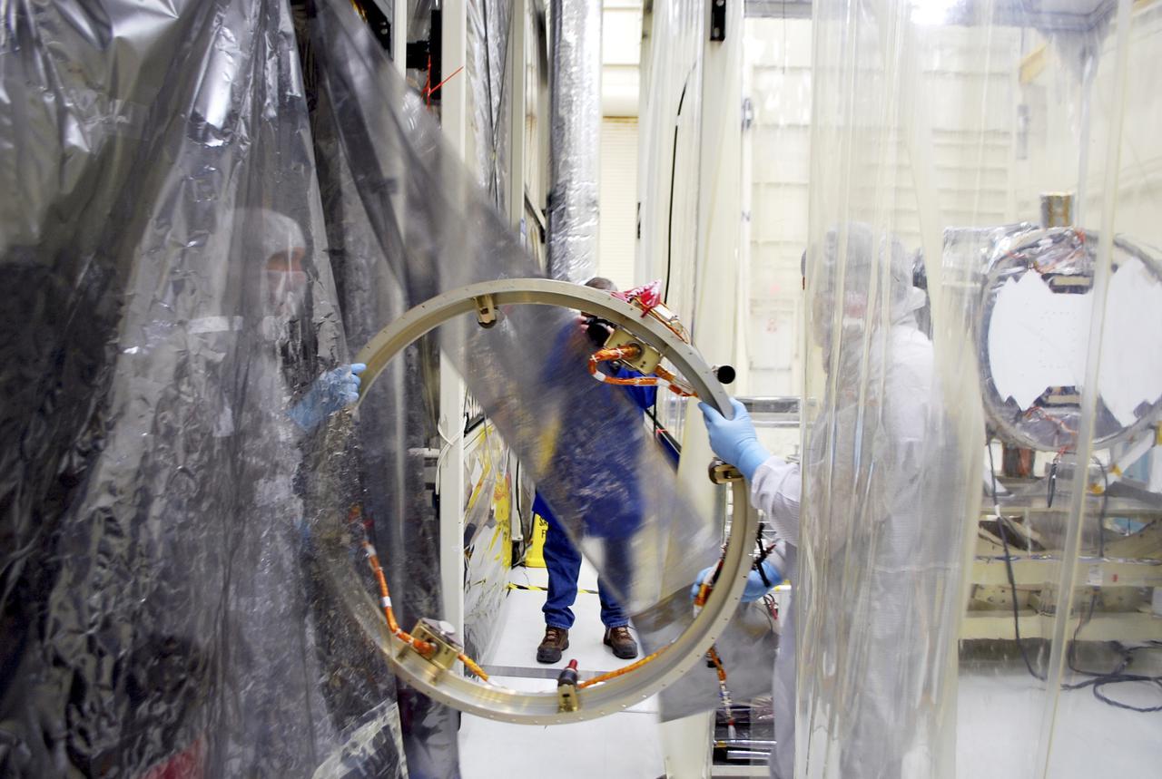 VANDENBERG AIR FORCE BASE, Calif. – At Vandenberg Air Force Base in California, technicians and engineers prepare a separation system ring that will be attached to NASA's Interface Region Imaging Spectrograph, or IRIS, spacecraft. The separation system will push IRIS away from an Orbital Pegasus XL rocket when the spacecraft reaches its proper orbit after launch.   Scheduled for launch from Vandenberg Air Force Base no earlier than June 26, 2013, IRIS will open a new window of discovery by tracing the flow of energy and plasma through the chromospheres and transition region into the sun’s corona using spectrometry and imaging. IRIS fills a crucial gap in our ability to advance studies of the sun-to-Earth connection by tracing the flow of energy and plasma through the foundation of the corona and the region around the sun known as the heliosphere. For more information, visit http:__iris.gsfc.nasa.gov Photo credit: NASA_Randy Beaudoin