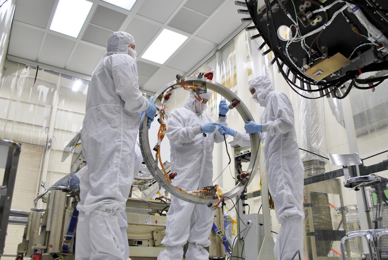 VANDENBERG AIR FORCE BASE, Calif. – At Vandenberg Air Force Base in California, technicians and engineers prepare a separation system ring that will be attached to NASA's Interface Region Imaging Spectrograph, or IRIS, spacecraft. The separation system will push IRIS away from an Orbital Pegasus XL rocket when the spacecraft reaches its proper orbit after launch.   Scheduled for launch from Vandenberg Air Force Base no earlier than June 26, 2013, IRIS will open a new window of discovery by tracing the flow of energy and plasma through the chromospheres and transition region into the sun’s corona using spectrometry and imaging. IRIS fills a crucial gap in our ability to advance studies of the sun-to-Earth connection by tracing the flow of energy and plasma through the foundation of the corona and the region around the sun known as the heliosphere. For more information, visit http:__iris.gsfc.nasa.gov Photo credit: NASA_Randy Beaudoin