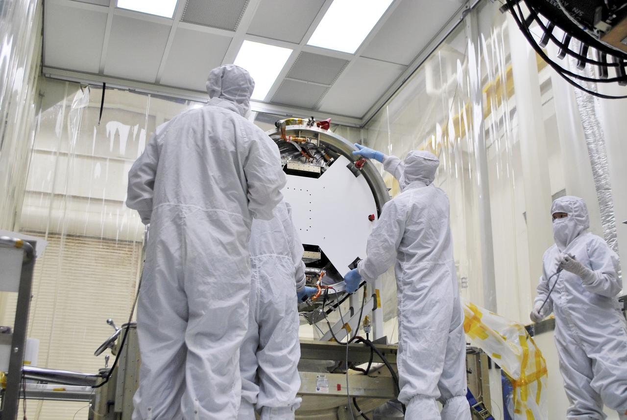 VANDENBERG AIR FORCE BASE, Calif. – At Vandenberg Air Force Base in California, technicians and engineers install a separation system ring that will be attached to NASA's Interface Region Imaging Spectrograph, or IRIS, spacecraft. The separation system will push IRIS away from an Orbital Pegasus XL rocket when the spacecraft reaches its proper orbit after launch.   Scheduled for launch from Vandenberg Air Force Base no earlier than June 26, 2013, IRIS will open a new window of discovery by tracing the flow of energy and plasma through the chromospheres and transition region into the sun’s corona using spectrometry and imaging. IRIS fills a crucial gap in our ability to advance studies of the sun-to-Earth connection by tracing the flow of energy and plasma through the foundation of the corona and the region around the sun known as the heliosphere. For more information, visit http:__iris.gsfc.nasa.gov Photo credit: NASA_Randy Beaudoin