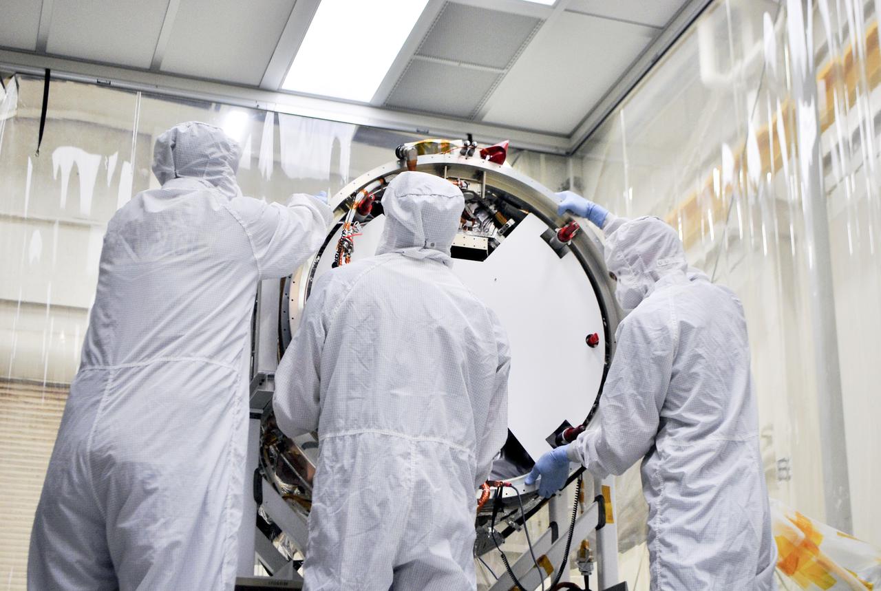 VANDENBERG AIR FORCE BASE, Calif. – At Vandenberg Air Force Base in California, technicians and engineers install a separation system ring that will be attached to NASA's Interface Region Imaging Spectrograph, or IRIS, spacecraft. The separation system will push IRIS away from an Orbital Pegasus XL rocket when the spacecraft reaches its proper orbit after launch.   Scheduled for launch from Vandenberg Air Force Base no earlier than June 26, 2013, IRIS will open a new window of discovery by tracing the flow of energy and plasma through the chromospheres and transition region into the sun’s corona using spectrometry and imaging. IRIS fills a crucial gap in our ability to advance studies of the sun-to-Earth connection by tracing the flow of energy and plasma through the foundation of the corona and the region around the sun known as the heliosphere. For more information, visit http:__iris.gsfc.nasa.gov Photo credit: NASA_Randy Beaudoin