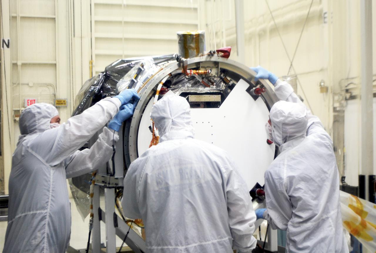 VANDENBERG AIR FORCE BASE, Calif. – At Vandenberg Air Force Base in California, technicians and engineers install a separation system ring that will be attached to NASA's Interface Region Imaging Spectrograph, or IRIS, spacecraft. The separation system will push IRIS away from an Orbital Pegasus XL rocket when the spacecraft reaches its proper orbit after launch.   Scheduled for launch from Vandenberg Air Force Base no earlier than June 26, 2013, IRIS will open a new window of discovery by tracing the flow of energy and plasma through the chromospheres and transition region into the sun’s corona using spectrometry and imaging. IRIS fills a crucial gap in our ability to advance studies of the sun-to-Earth connection by tracing the flow of energy and plasma through the foundation of the corona and the region around the sun known as the heliosphere. For more information, visit http:__iris.gsfc.nasa.gov Photo credit: NASA_Randy Beaudoin