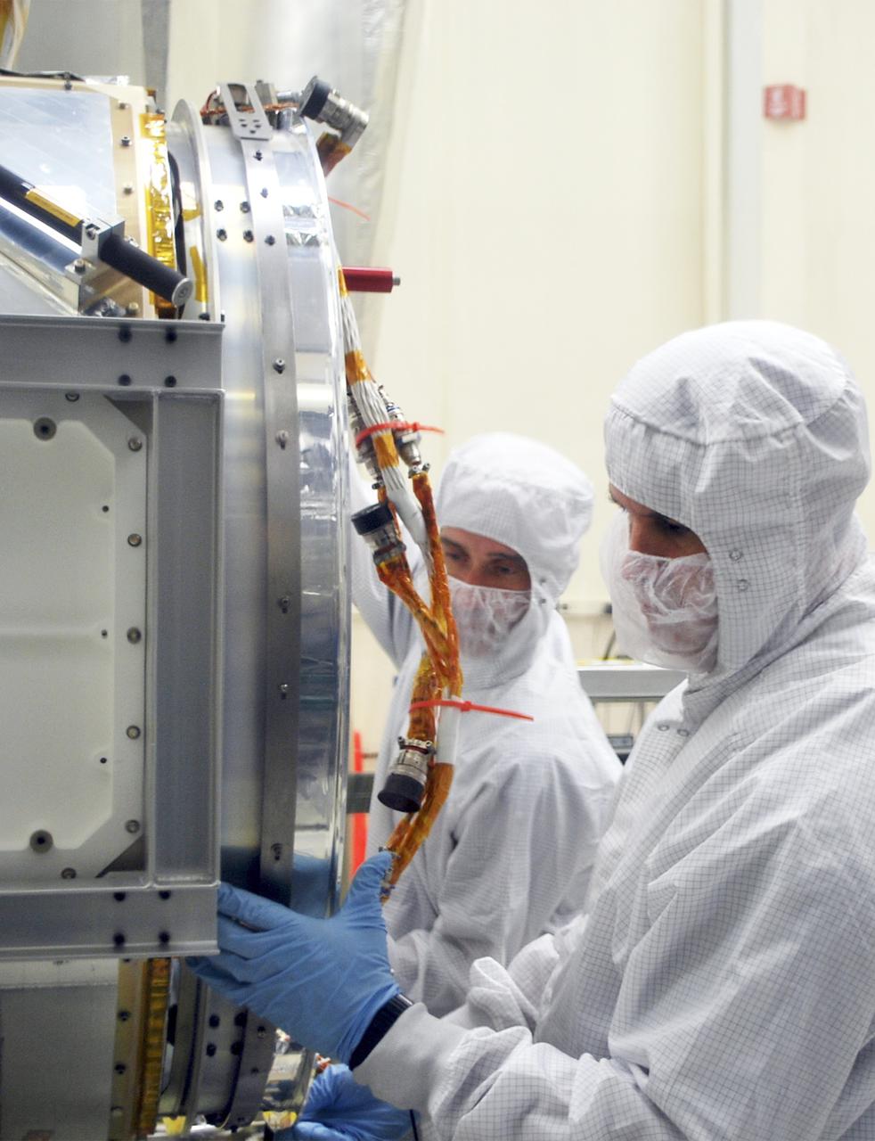 VANDENBERG AIR FORCE BASE, Calif. – At Vandenberg Air Force Base in California, technicians and engineers install a separation system ring that will be attached to NASA's Interface Region Imaging Spectrograph, or IRIS, spacecraft. The separation system will push IRIS away from an Orbital Pegasus XL rocket when the spacecraft reaches its proper orbit after launch.   Scheduled for launch from Vandenberg Air Force Base no earlier than June 26, 2013, IRIS will open a new window of discovery by tracing the flow of energy and plasma through the chromospheres and transition region into the sun’s corona using spectrometry and imaging. IRIS fills a crucial gap in our ability to advance studies of the sun-to-Earth connection by tracing the flow of energy and plasma through the foundation of the corona and the region around the sun known as the heliosphere. For more information, visit http:__iris.gsfc.nasa.gov Photo credit: NASA_Randy Beaudoin