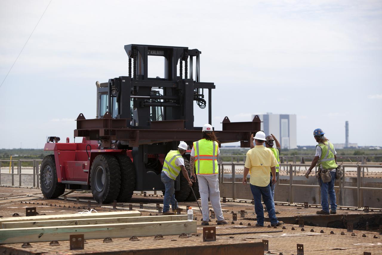 CAPE CANAVERAL, Fla. – At Launch Pad 39B at NASA’s Kennedy Space Center in Florida, removal of the crawler track panels on the pad’s surface is underway. The concrete surface beneath the panels and the catacomb roof below will be inspected for water damage and repaired.  There are 176 panels, each weighing about 30,000 pounds that will be removed. Launch Pad 39B is being refurbished to support NASA’s Space Launch System and other launch vehicles. The Ground Systems Development and Operations, or GSDO, Program office at Kennedy is leading the center’s transformation to safely handle a variety of rockets and spacecraft. For more information about GSDO, visit: http:__go.nasa.gov_groundsystems.  Photo credit: NASA_Dimitri Gerondidakis