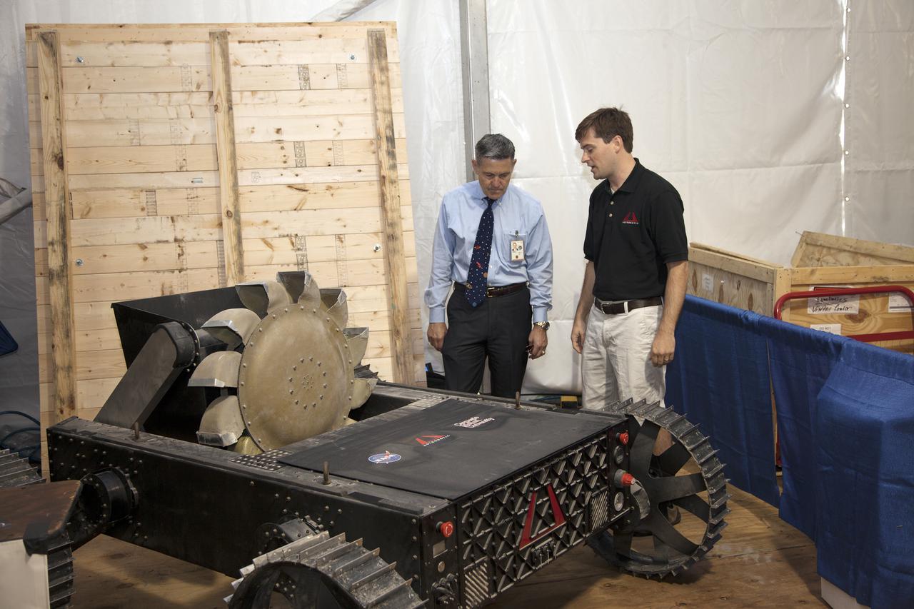 CAPE CANAVERAL, Fla. – At NASA’s Kennedy Space Center Visitor Complex in Florida, Kennedy Center Director Bob Cabana looks at the Polaris rover on display at NASA’s Fourth Annual Robotic Mining Competition. Developed by Astrobotic Technologies Inc. under a Small Business Innovative Research contract, Polaris will be demonstrated during the competition that takes place through May 24.   The mining competition is coordinated by Kennedy Space Center’s Education Office for the agency’s Exploration Systems Mission Directorate. Undergraduate and graduate students from 50 universities and colleges in the U.S. and eight countries around the world will use their remote-controlled robots to maneuver and dig in a supersized sandbox filled with a crushed material called regolith that has characteristics similar to asteroids, moons of Mars and Mars itself. Photo credit: NASA_Lorne Mathre